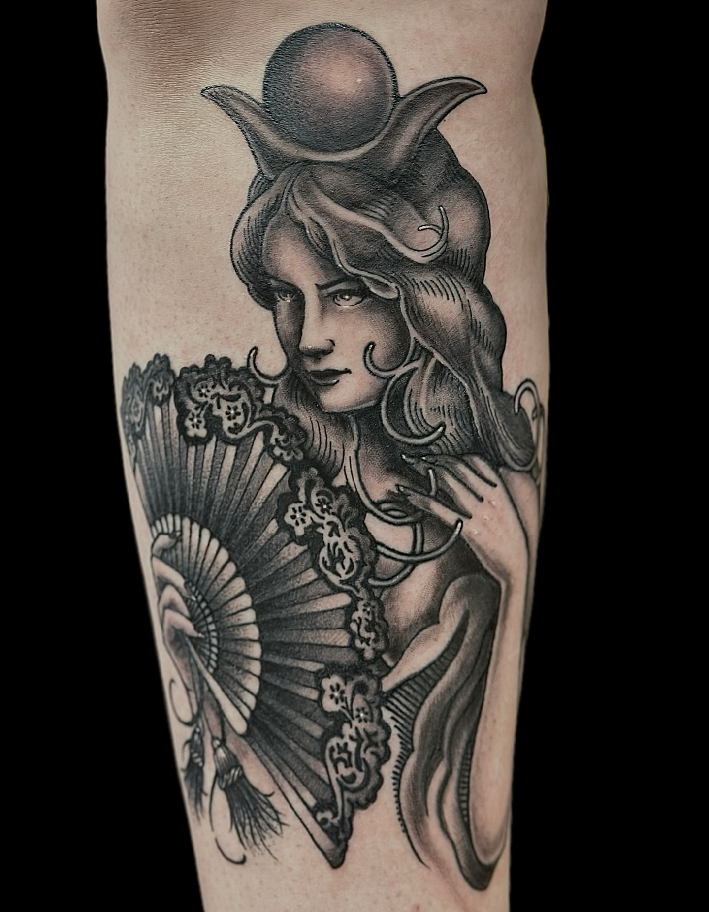 Woman with fan realism tattoo on the forearm by Madeline Brown