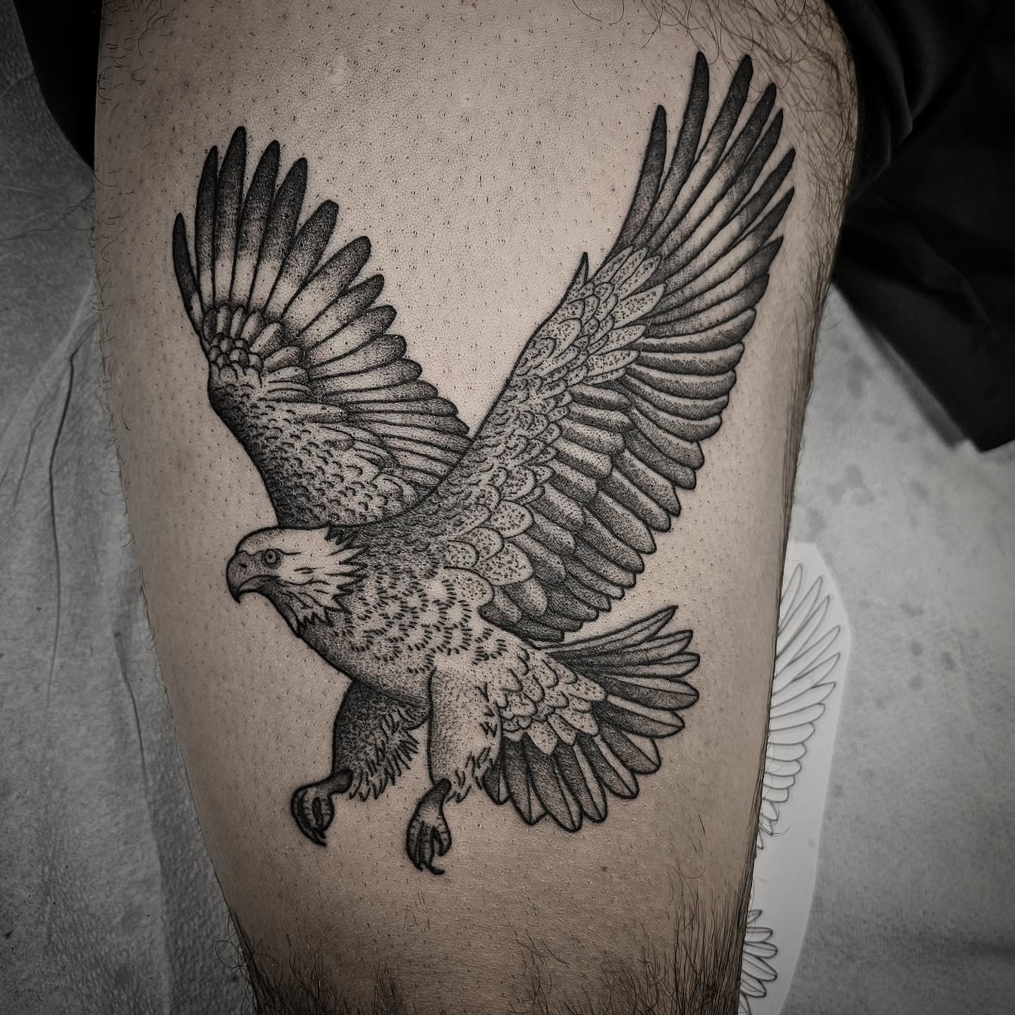 Eagle dotwork tattoo on the thigh by Kirk George