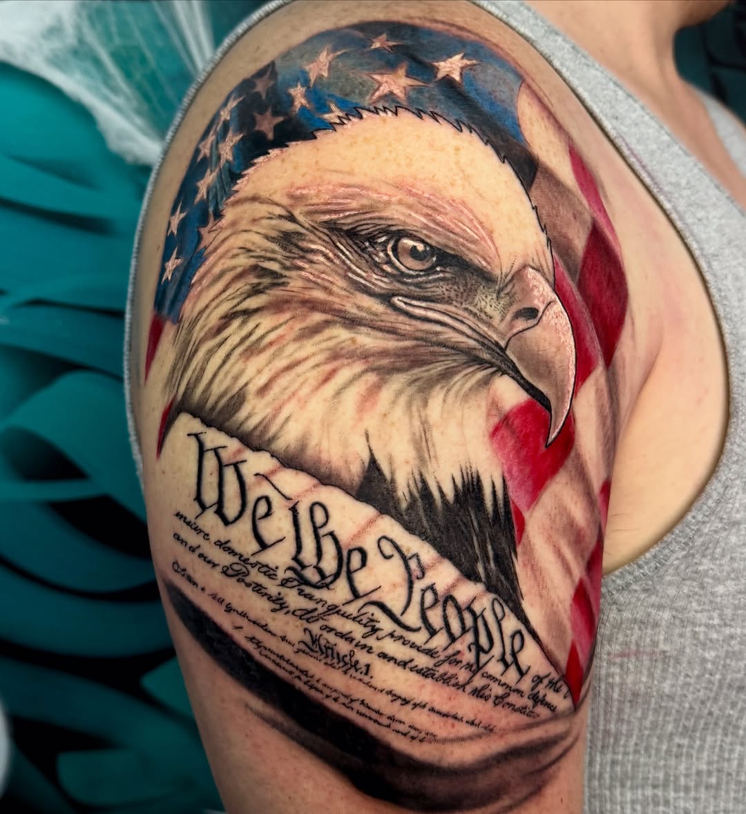 Eagle and american flag with text realism tattoo on the forearm by Jarrod Gatzke