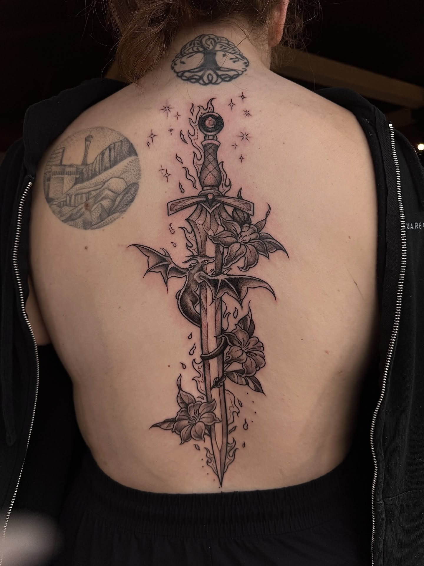 Sword and flowers realism tattoo on the back by Jewels, St. George, Utah