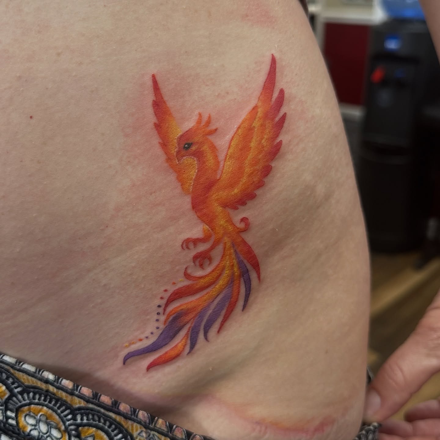 Phoenix dotwork tattoo on the thigh by Bosco Layne