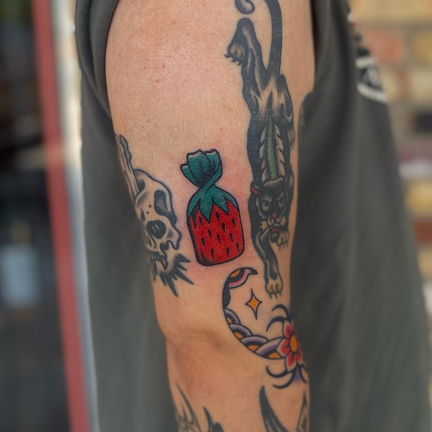 Strawberry bag American traditional tattoo on the forearm by Myka King