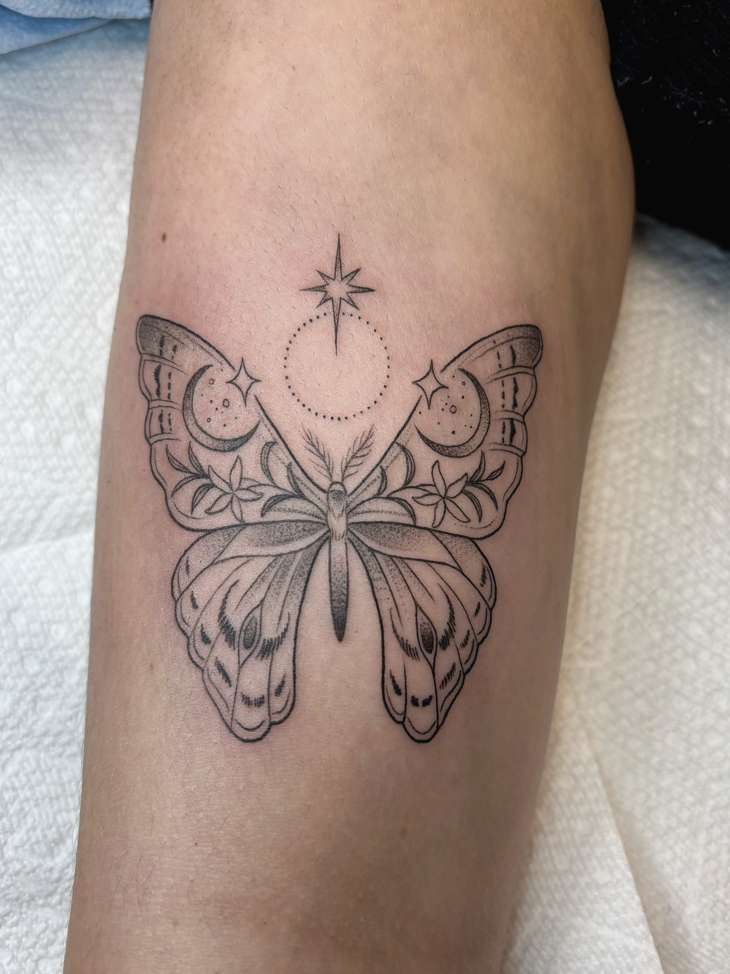 Butterfly black and grey tattoo on the forearm by Fineline tattoos by Kinsey