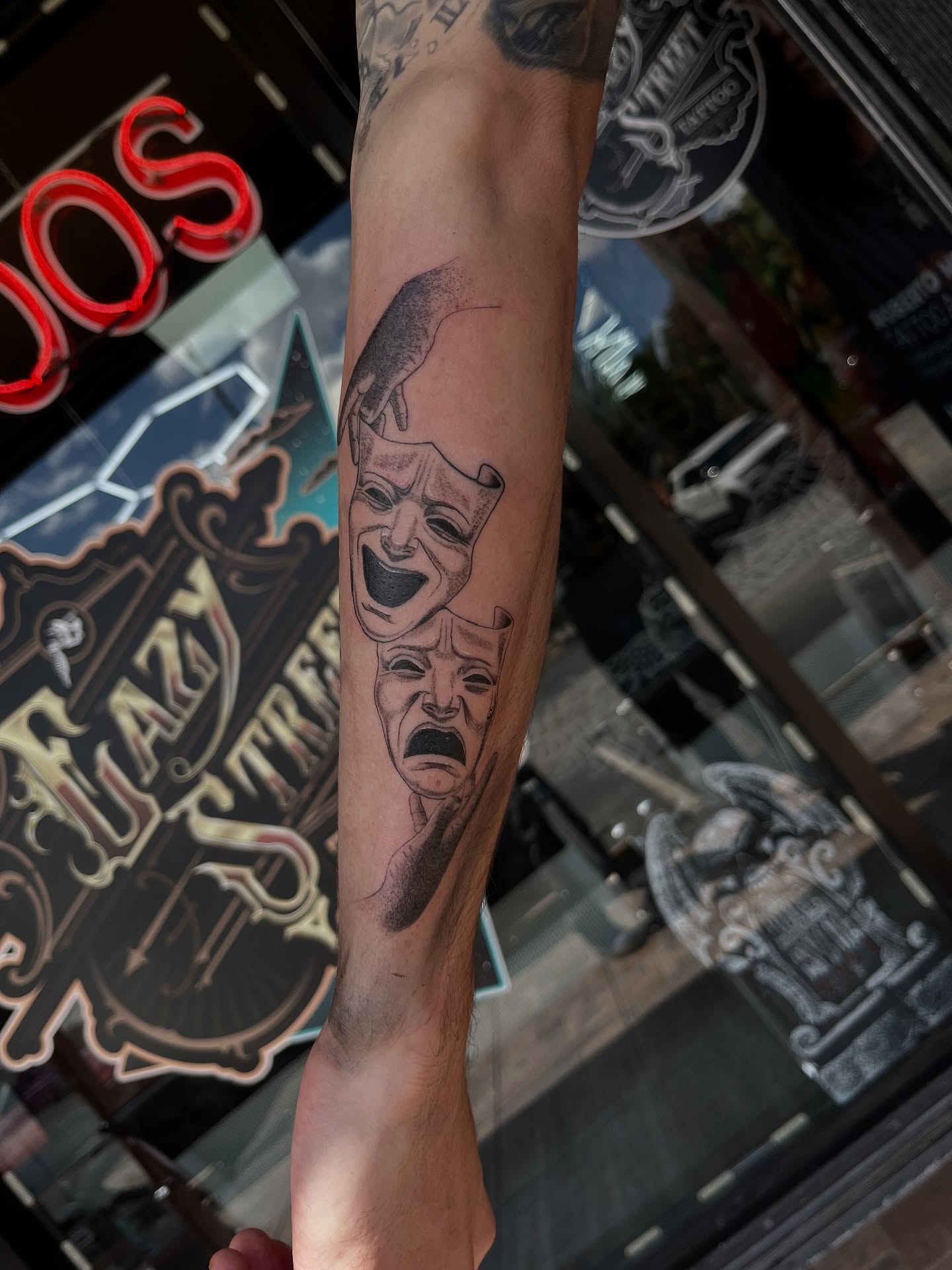 Theater masks dotwork tattoo on the forearm by Elijah Cosme, Miami, Florida