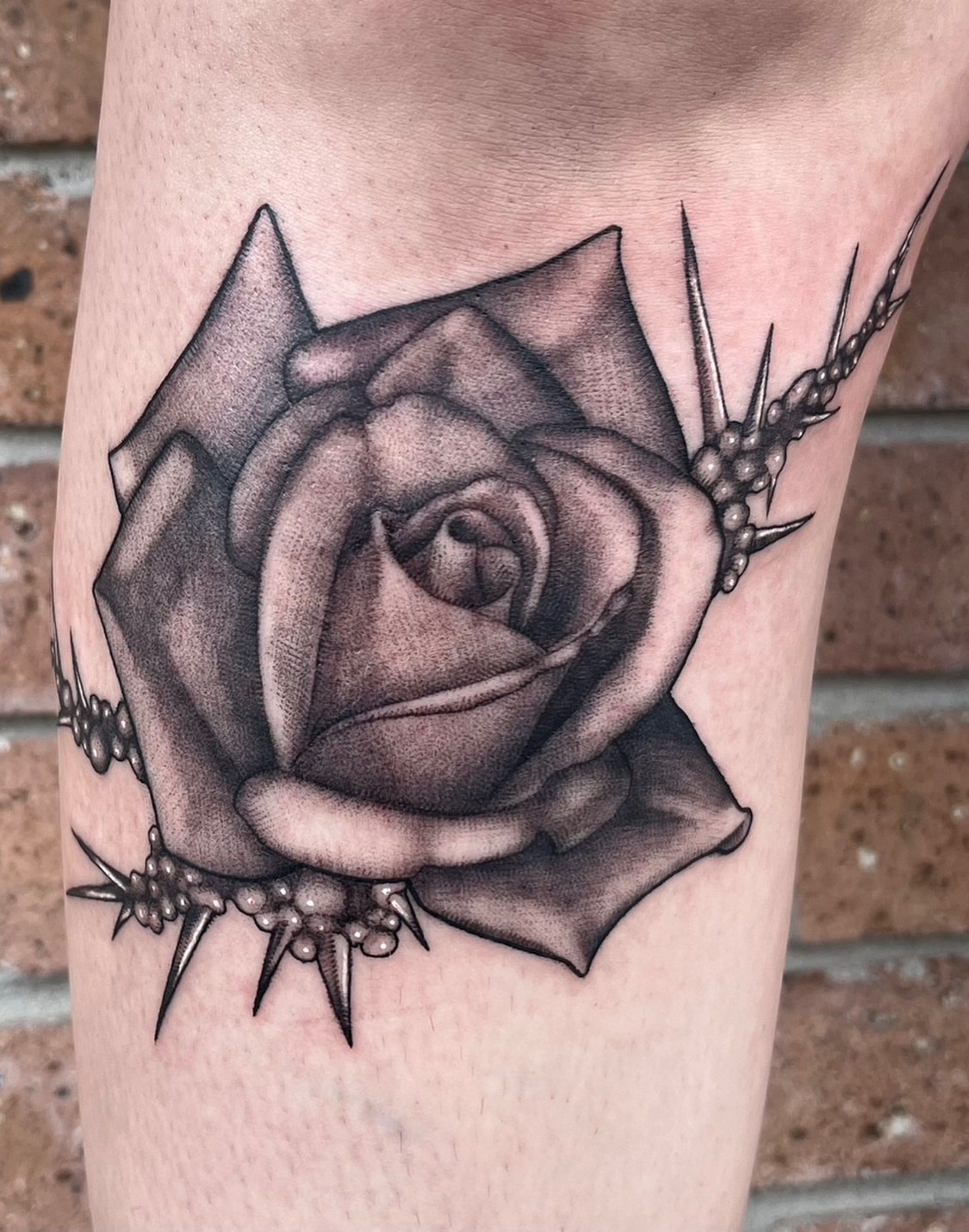 Rose with thorns realism tattoo on the forearm by Myla Jane, Houston, Texas