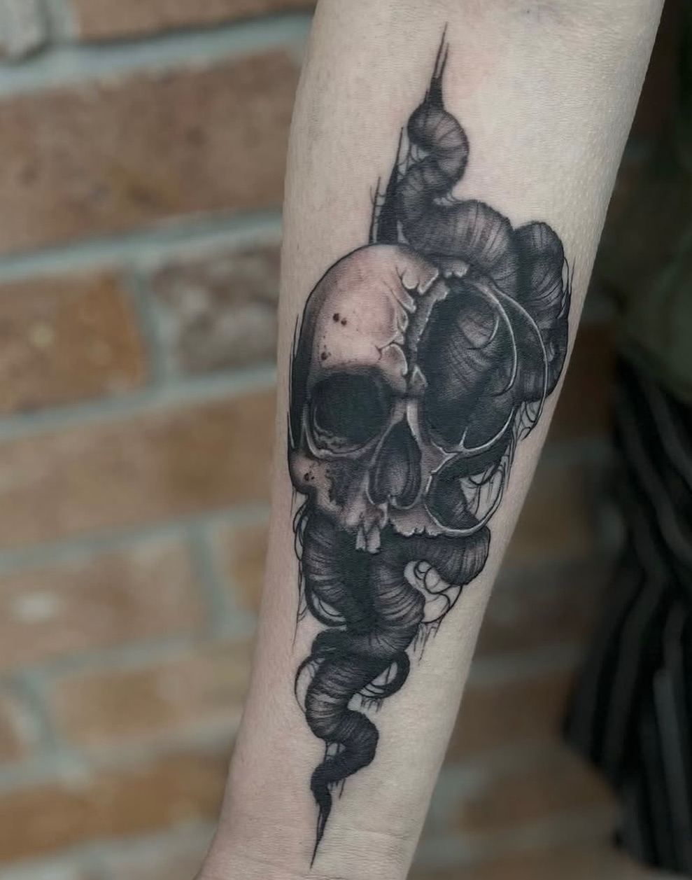 Skull with tentacles realism tattoo on the forearm by Myla Jane, Houston, Texas