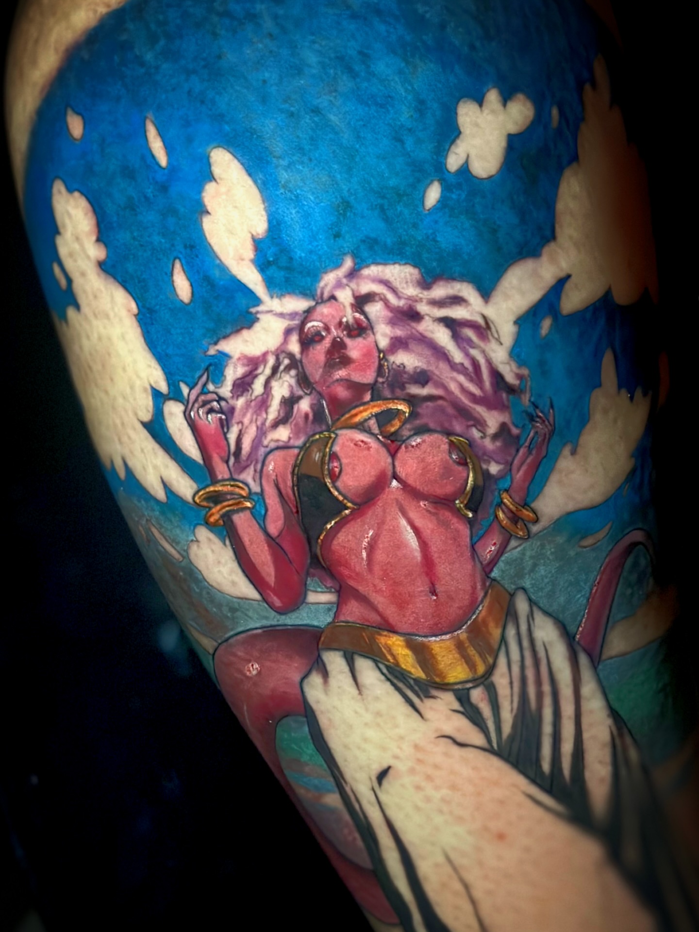 Woman with clouds illustrative tattoo on the upper arm by Davone Joyner, Richmond, Virginia