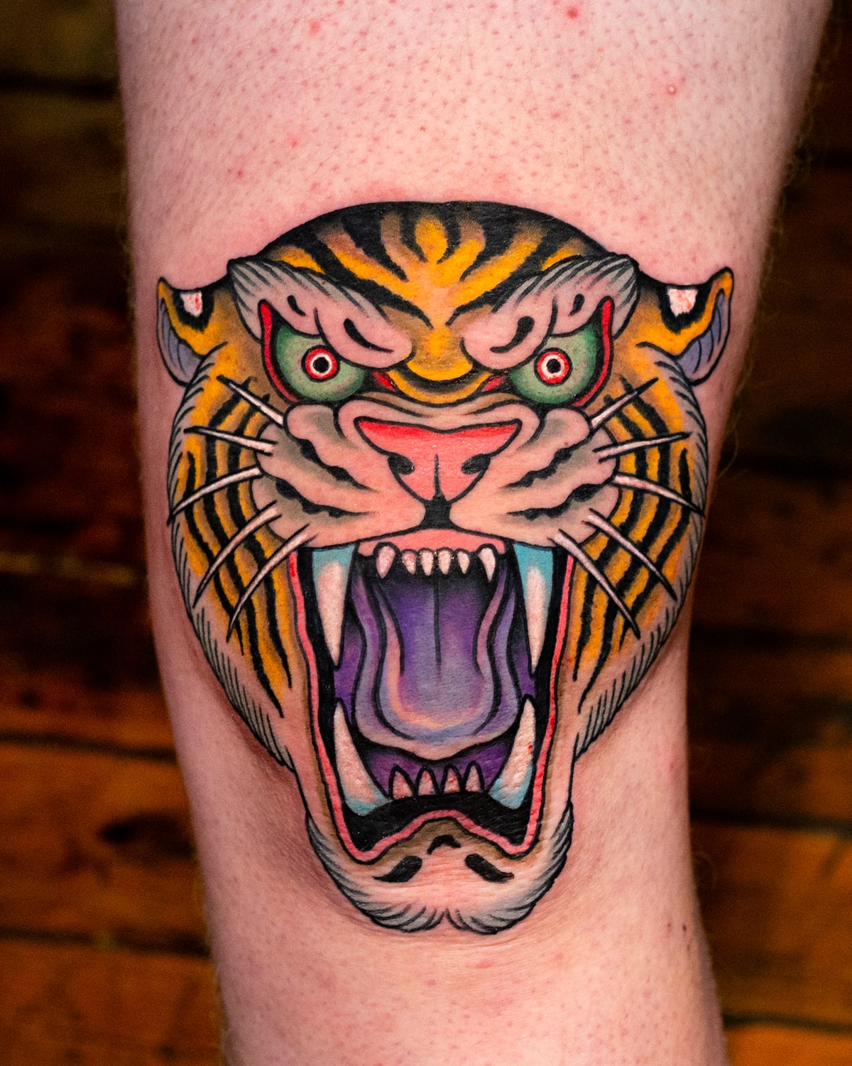 Roaring tiger American traditional tattoo on the forearm by Miguel Comin