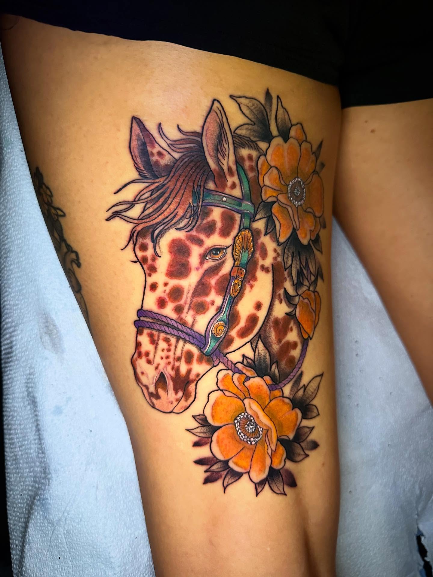 Giraffe and flowers American traditional tattoo on the thigh by Sierra