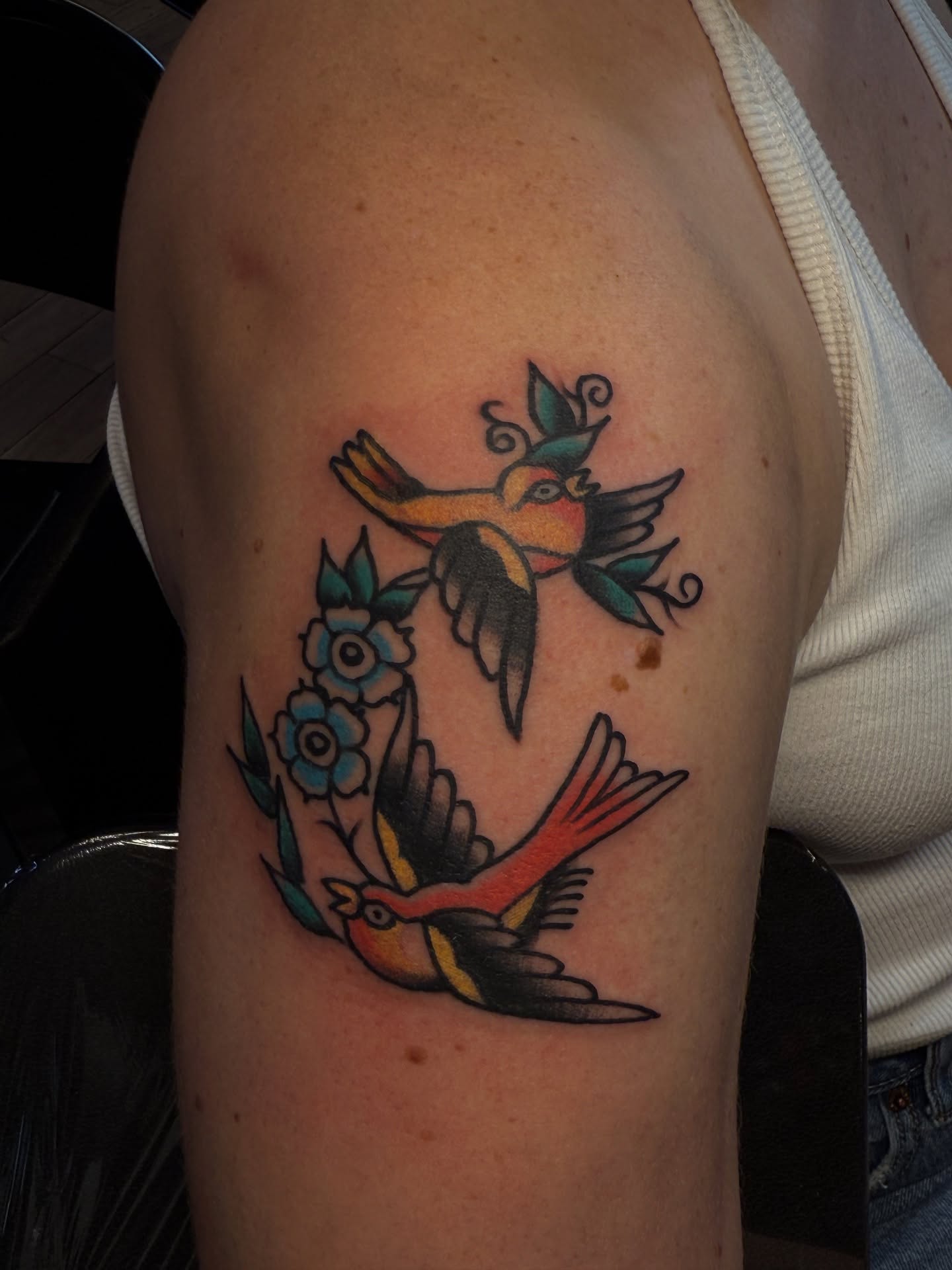 Birds and flowers American traditional tattoo on the shoulder by Zac Clark