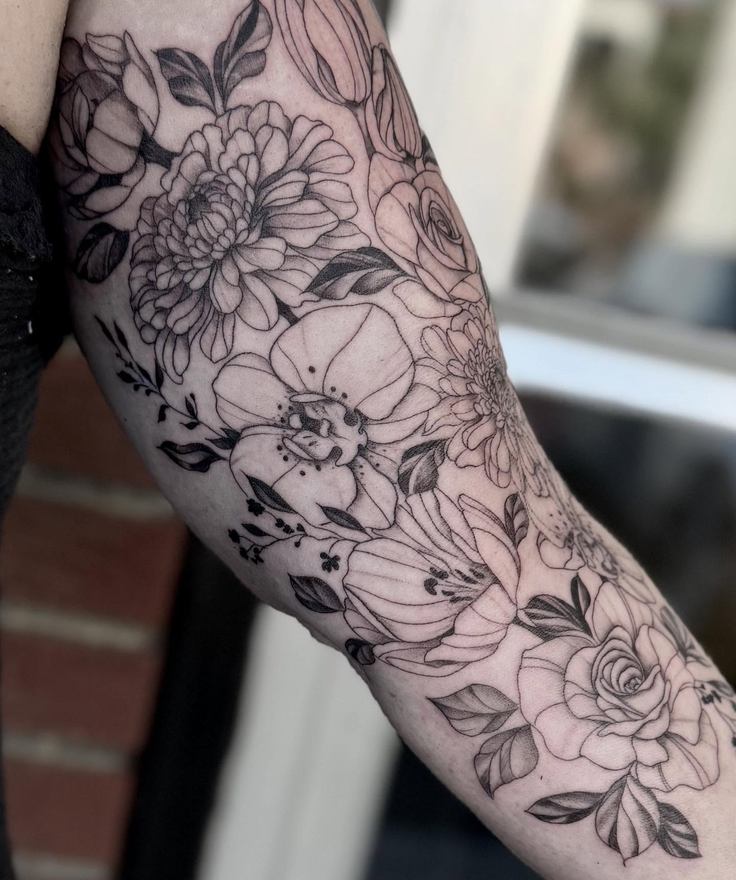 Floral bouquet black and grey tattoo on the forearm by Emmy