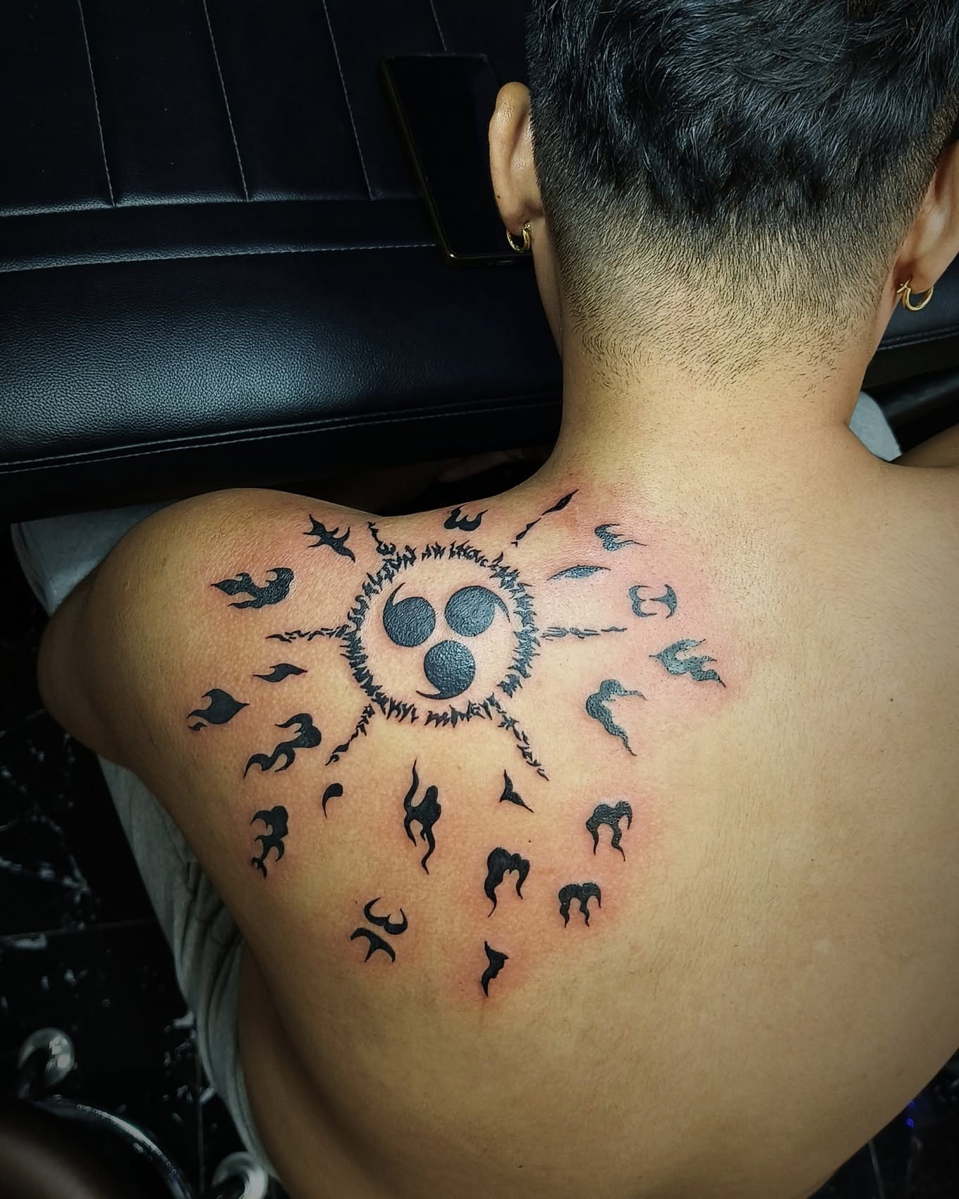 Sunburst with birds black and grey tattoo on the back by Peter John