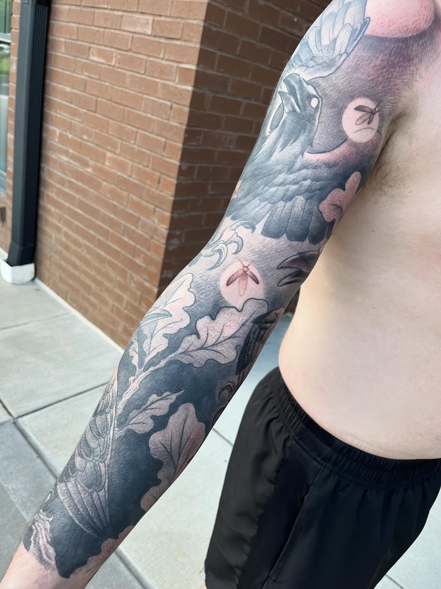 Bird and floral realism tattoo on the forearm by Ian White