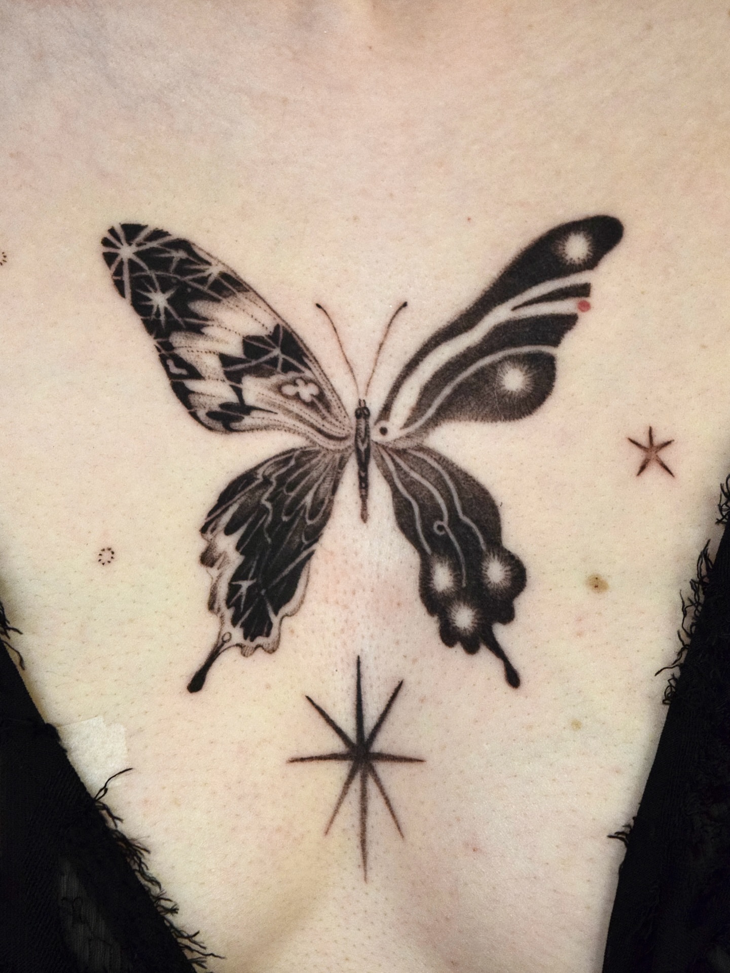 Butterfly black and grey tattoo on the chest by Stella Oh
