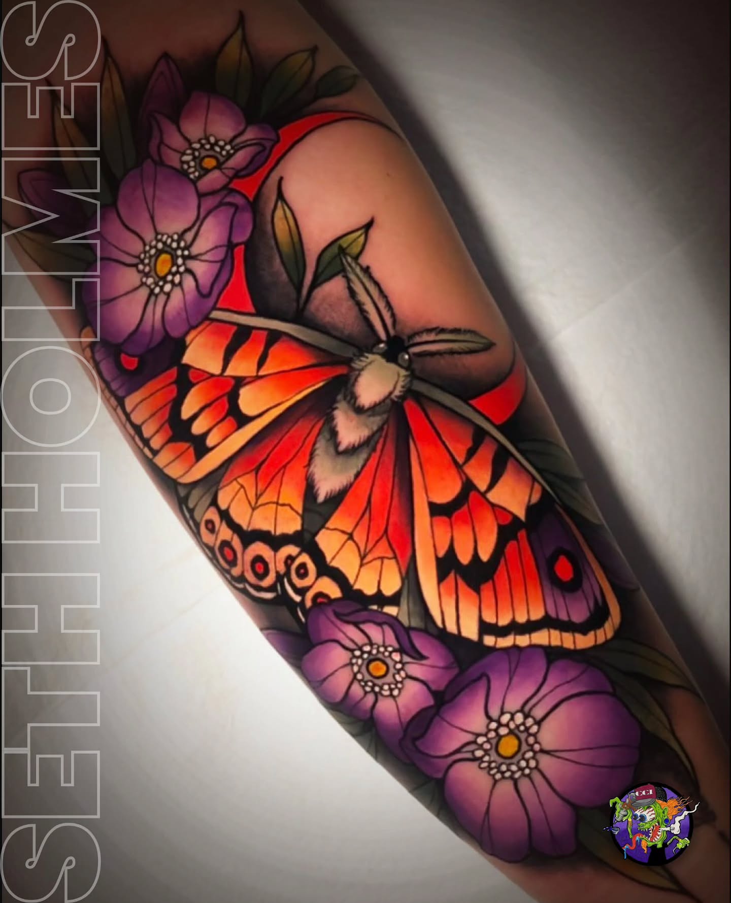 Butterfly and flowers American traditional tattoo on the forearm by Seth Holmes