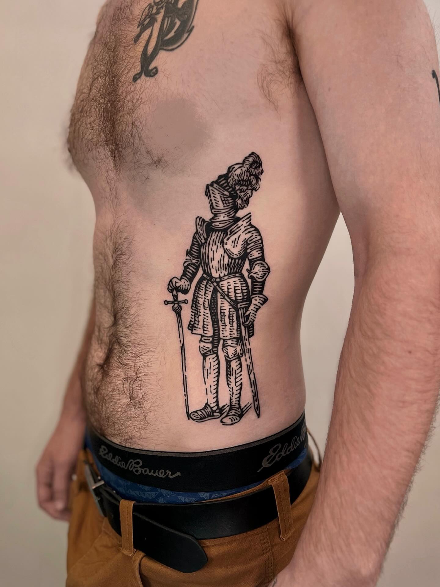 Knight black and grey tattoo on the torso by Wonny