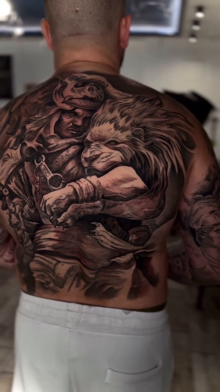 Warrior and lion realism tattoo by Tony Ink