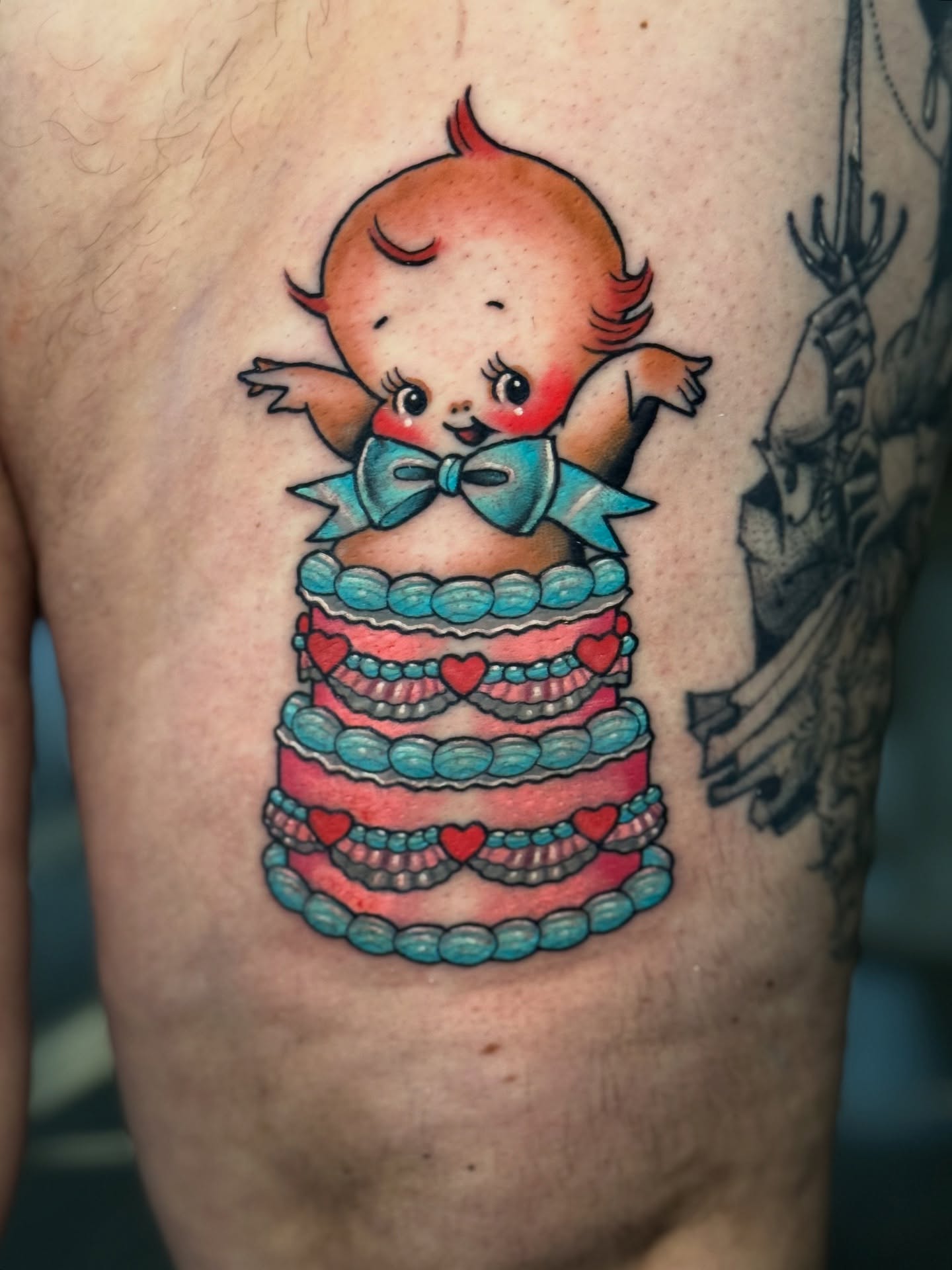 Baby cake new school tattoo on the chest by Stacey Martin Smith