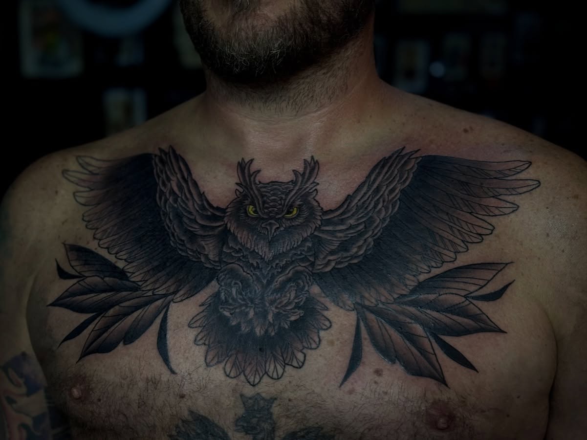 Owl black and grey tattoo on the chest by Stevie Reign