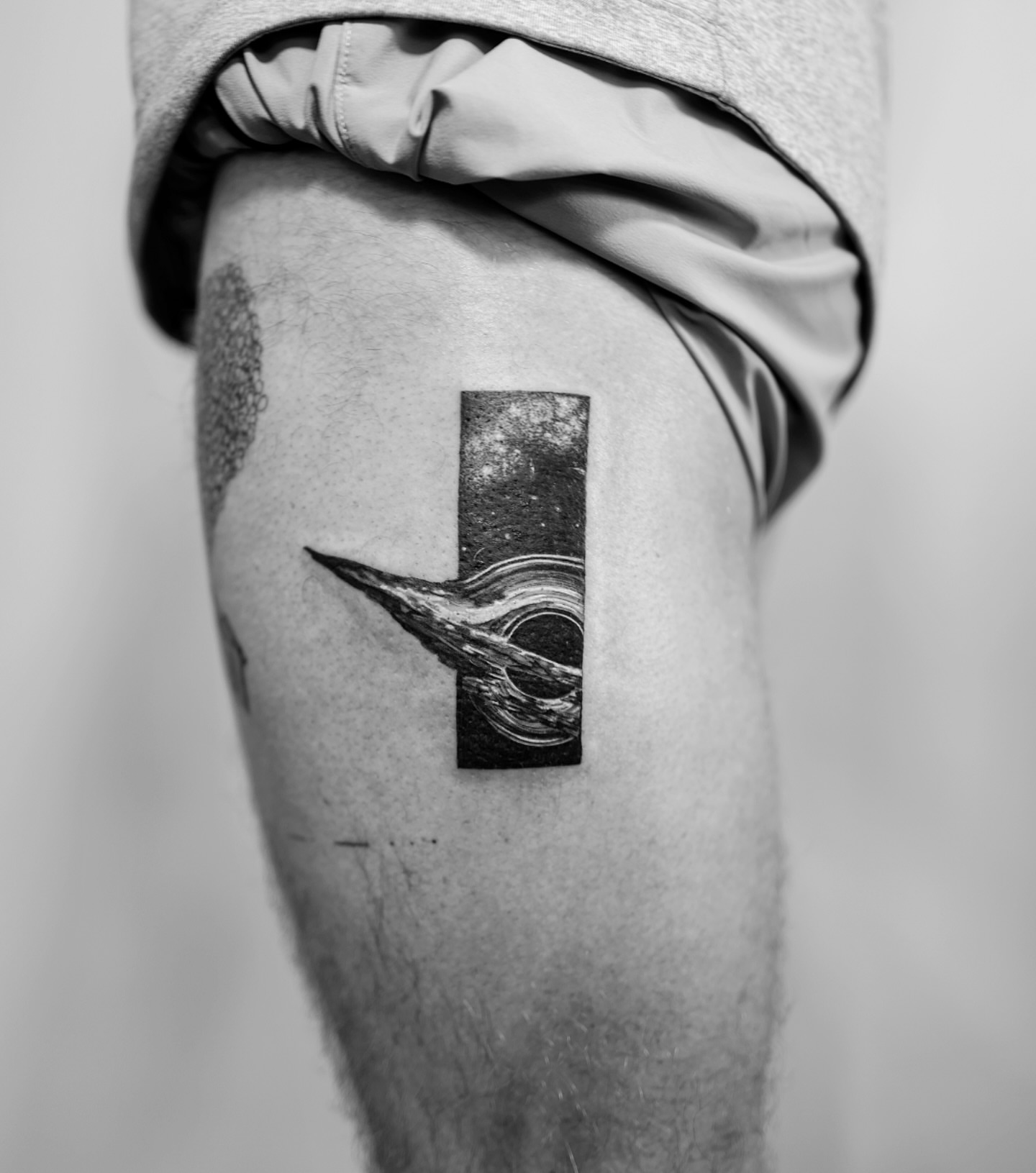 Abstract cosmic scene geometric tattoo on the thigh by Ross Clark Tattoos
