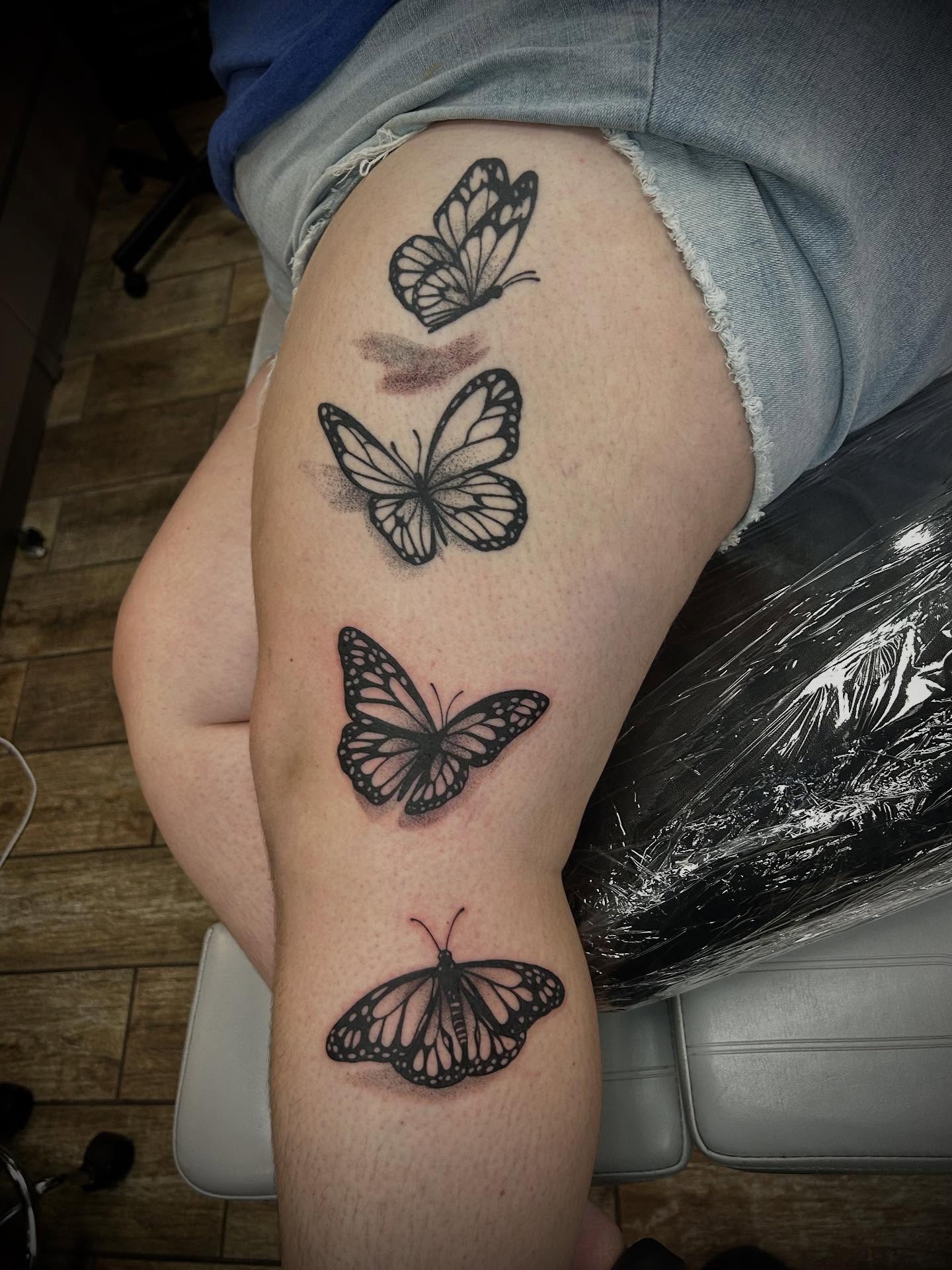 Butterflies black and grey tattoo on the thigh by ✶ 𝓑𝓲𝓽𝓮𝓼𝓲𝔃𝓮𝓭 𝓘𝓷𝓴 ✶, Buford, Georgia