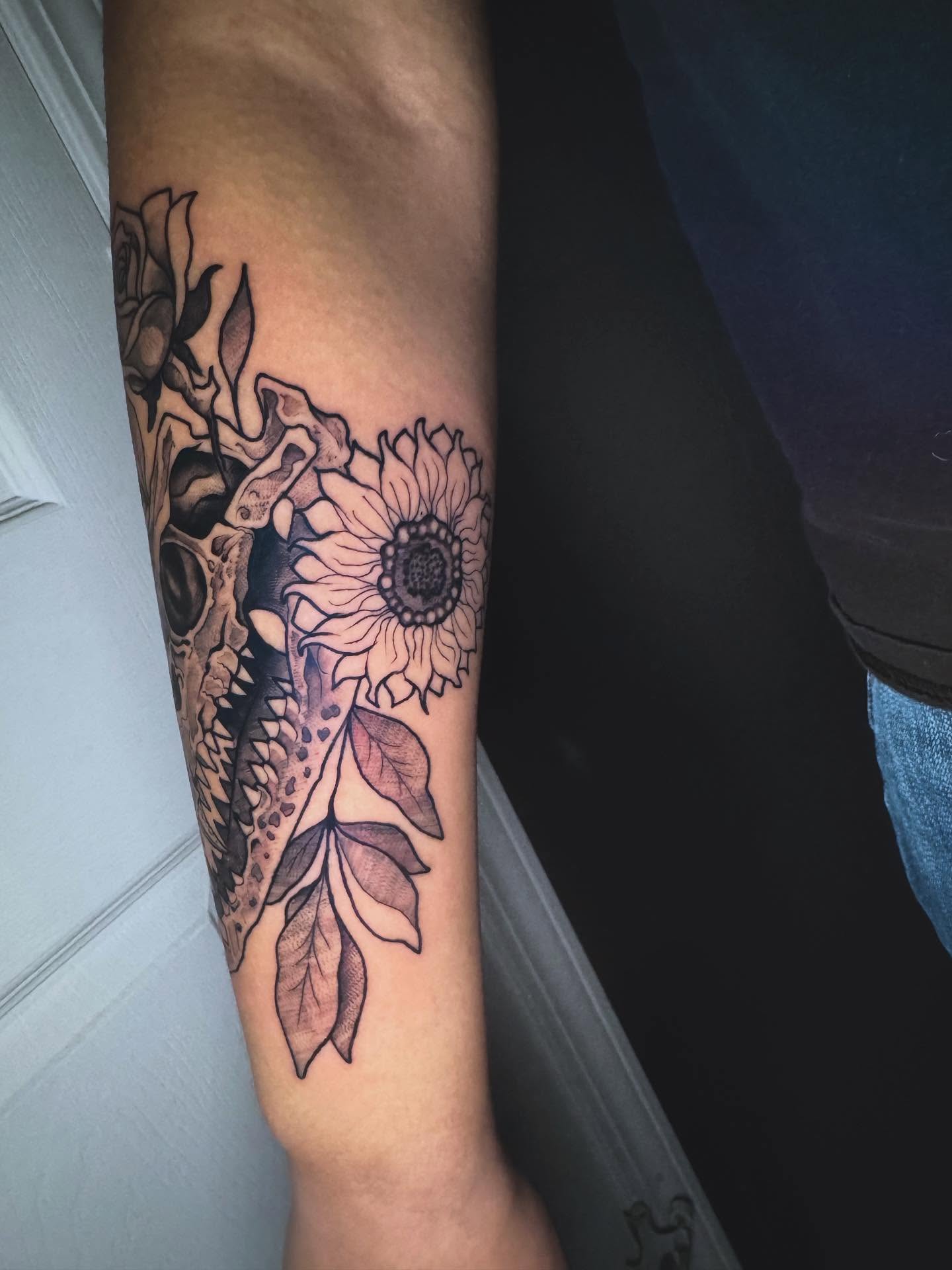 Sunflower and skull realism tattoo on the forearm by Kayla Rosencrans