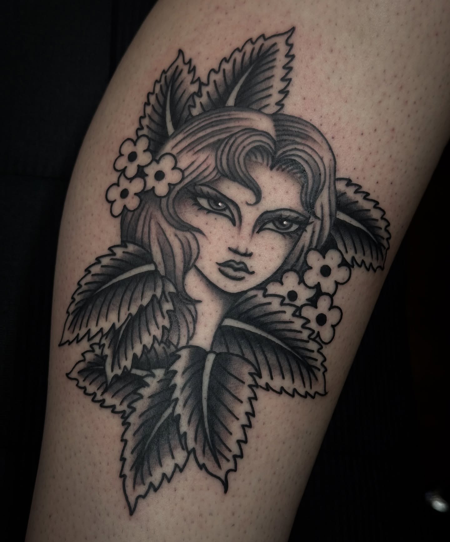 Woman with flowers black and grey tattoo on the thigh by Ally noel