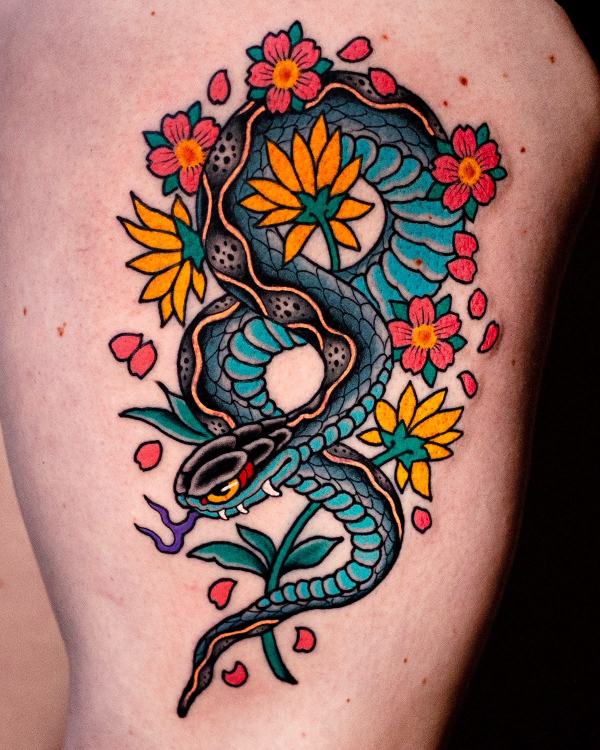 Snake and flowers American traditional tattoo on the thigh by Miguel Comin