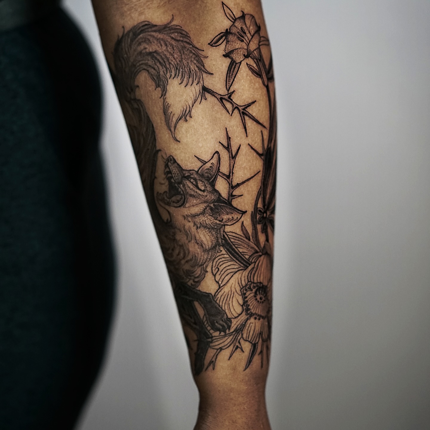 Wolf and flowers realism tattoo on the forearm by H I R A  L U P E - tattoo artist, Oakland, California
