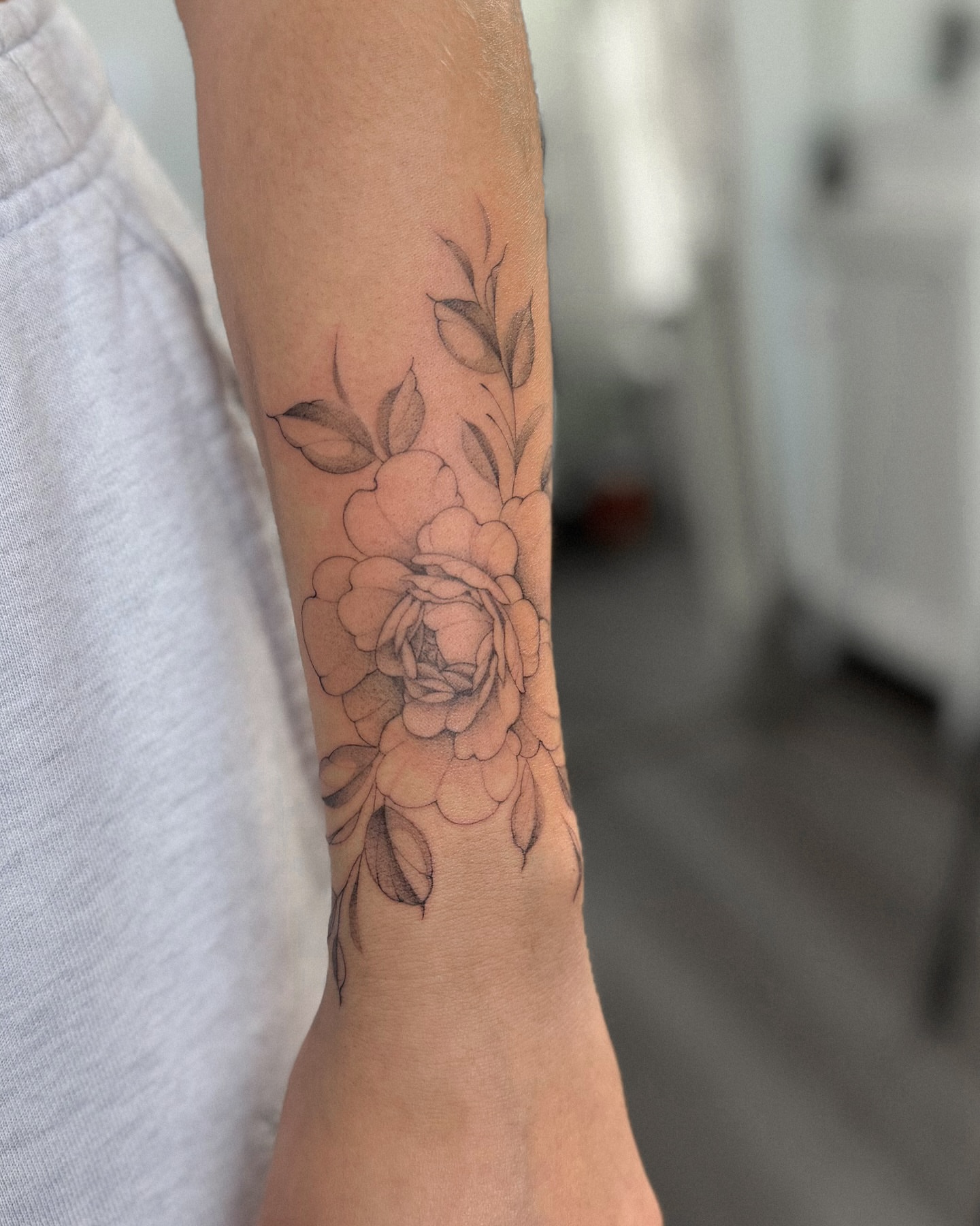 Floral bouquet black and grey tattoo on the forearm by Daniel Montoya, Charlotte, North Carolina
