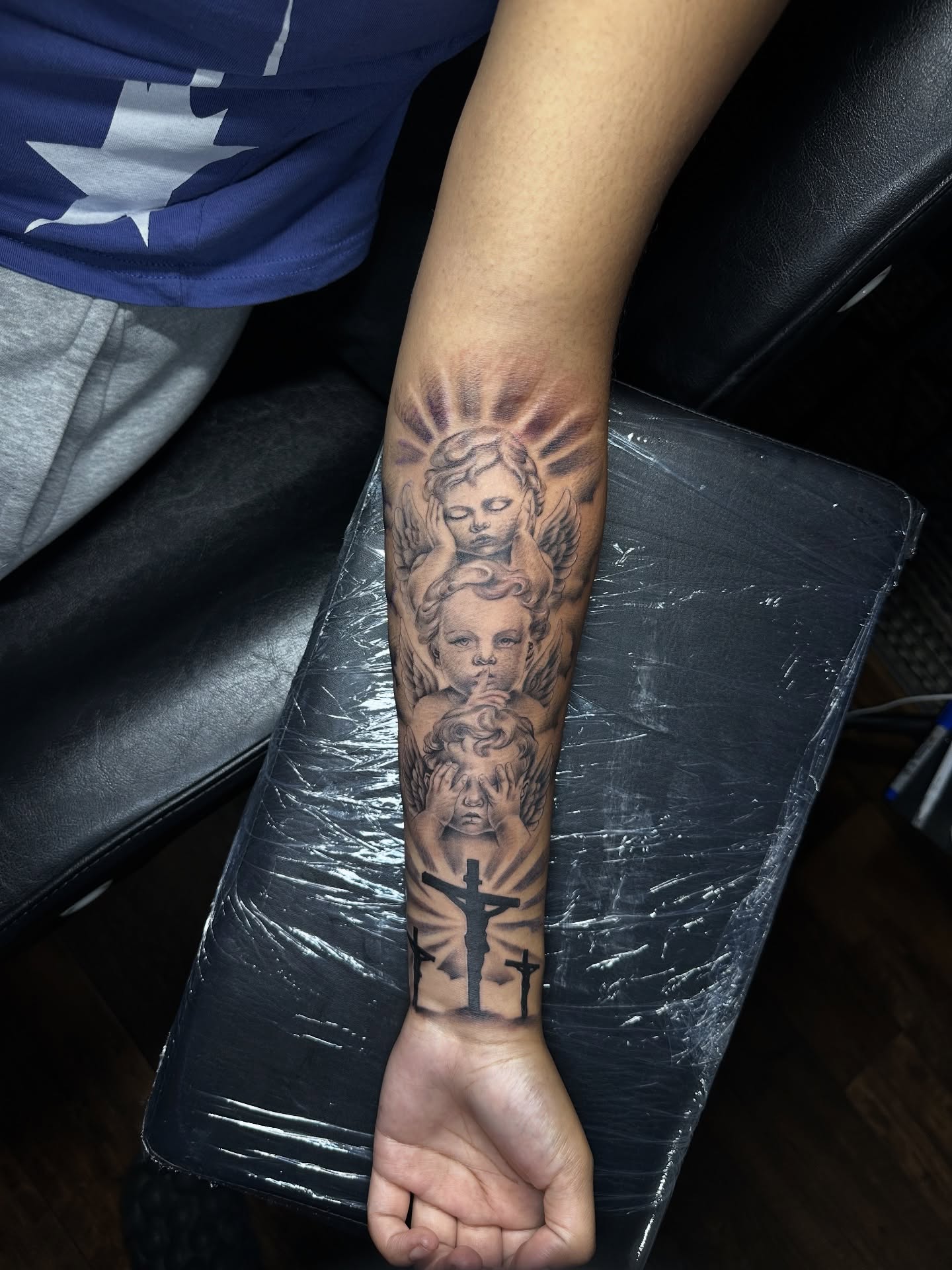 Religious imagery black and grey tattoo on the forearm by Chris (Pikasso)