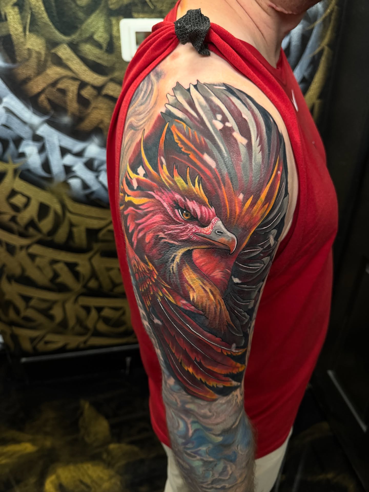 Phoenix realism tattoo on the upper arm by Fernando Luna