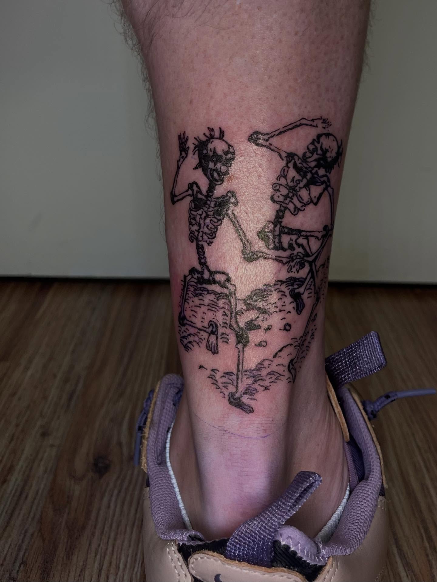 Skeletons dancing black and grey tattoo on the calf by J❄️, Portland, Oregon