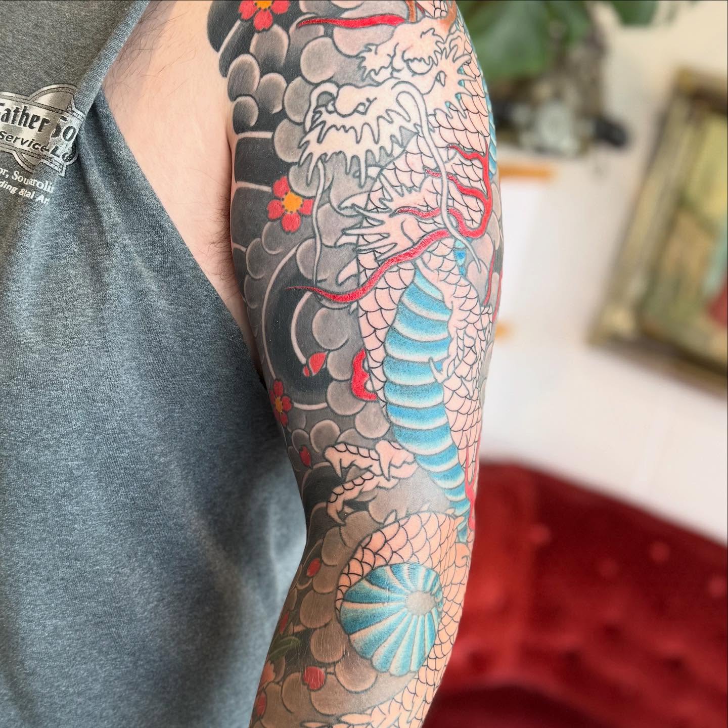 Dragon and flowers japanese irezumi tattoo on the forearm by Jason Eisenberg