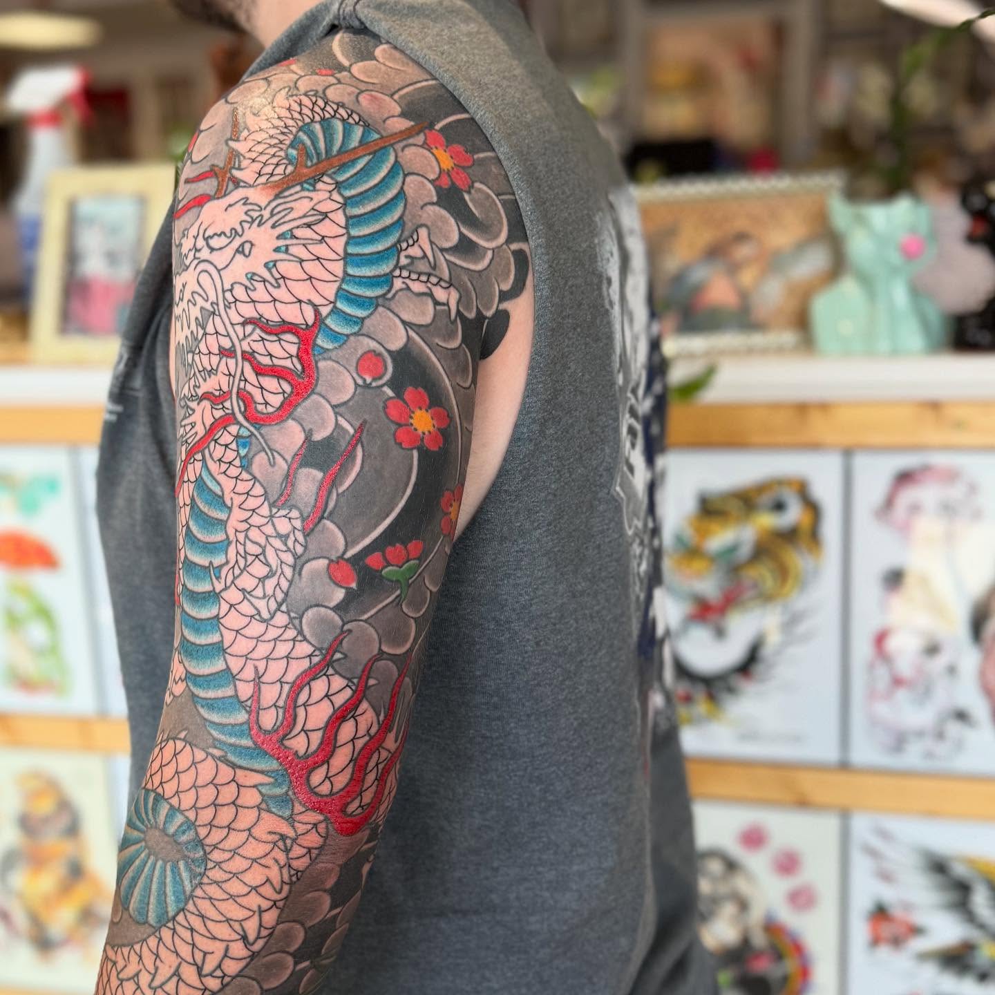 Dragon and flowers japanese irezumi tattoo on the upper arm by Jason Eisenberg