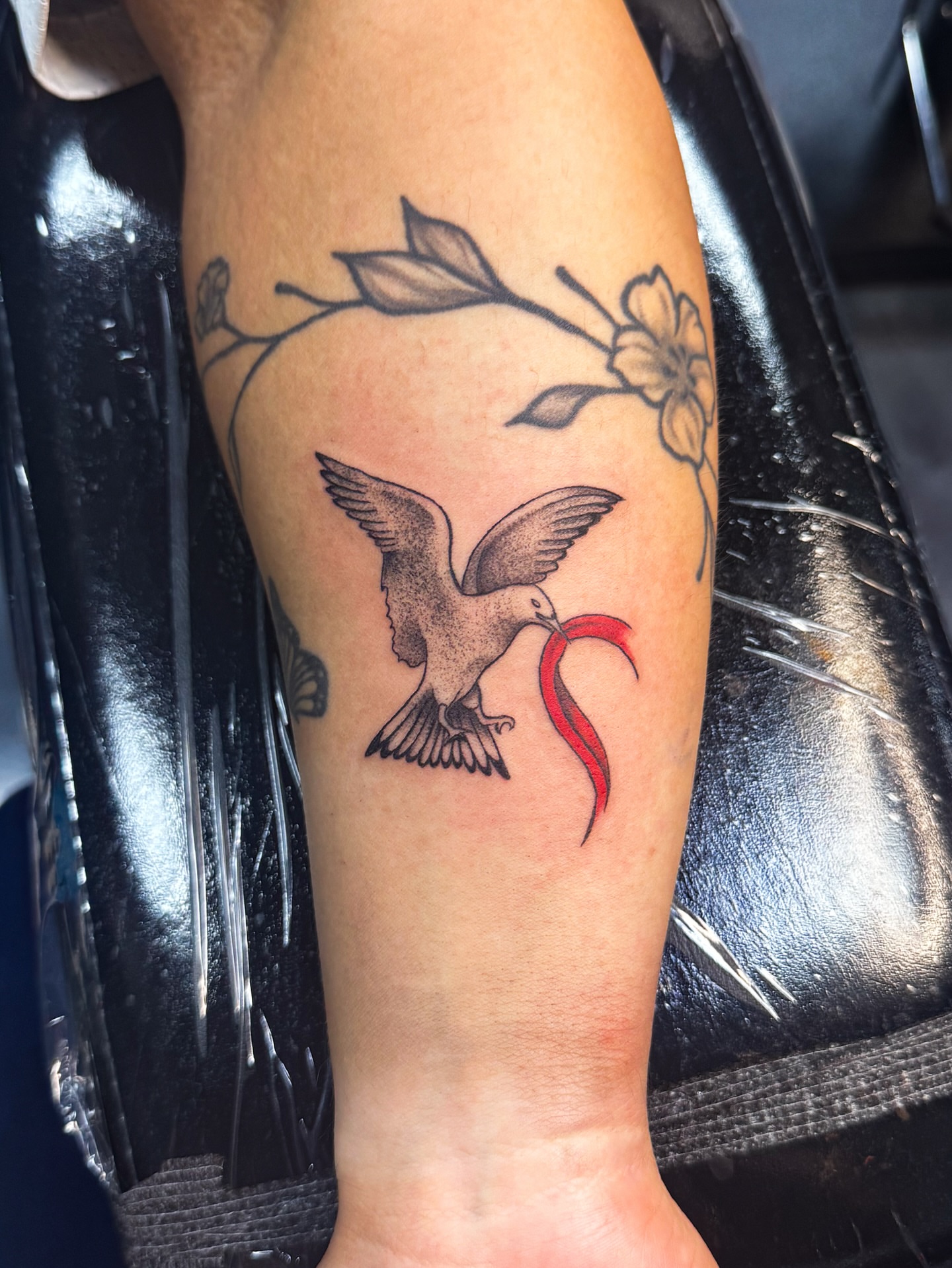 Bird with chili pepper dotwork tattoo on the forearm by Marie Amor🌙