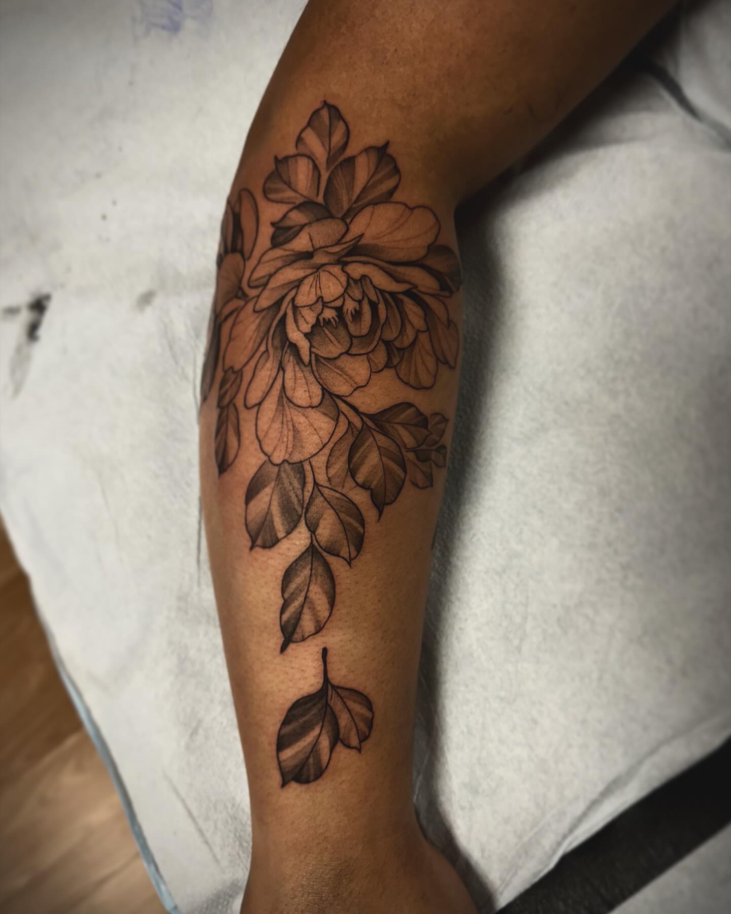 Flower black and grey tattoo on the forearm by Sebastian Livingston