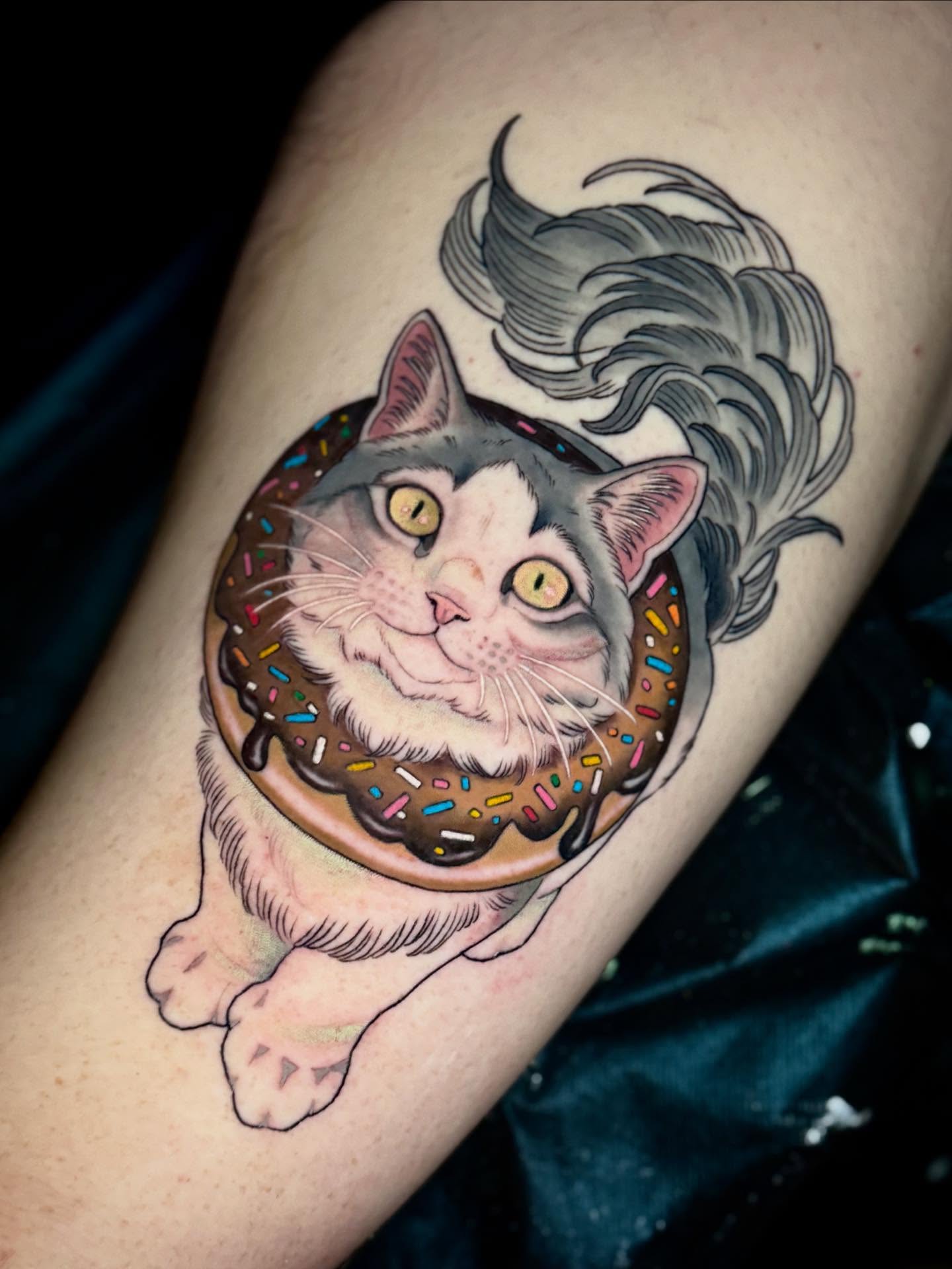 Cat in donut realism tattoo on the forearm by Andi Fitz ✨ San Diego Tattoo Artist, San Diego, California