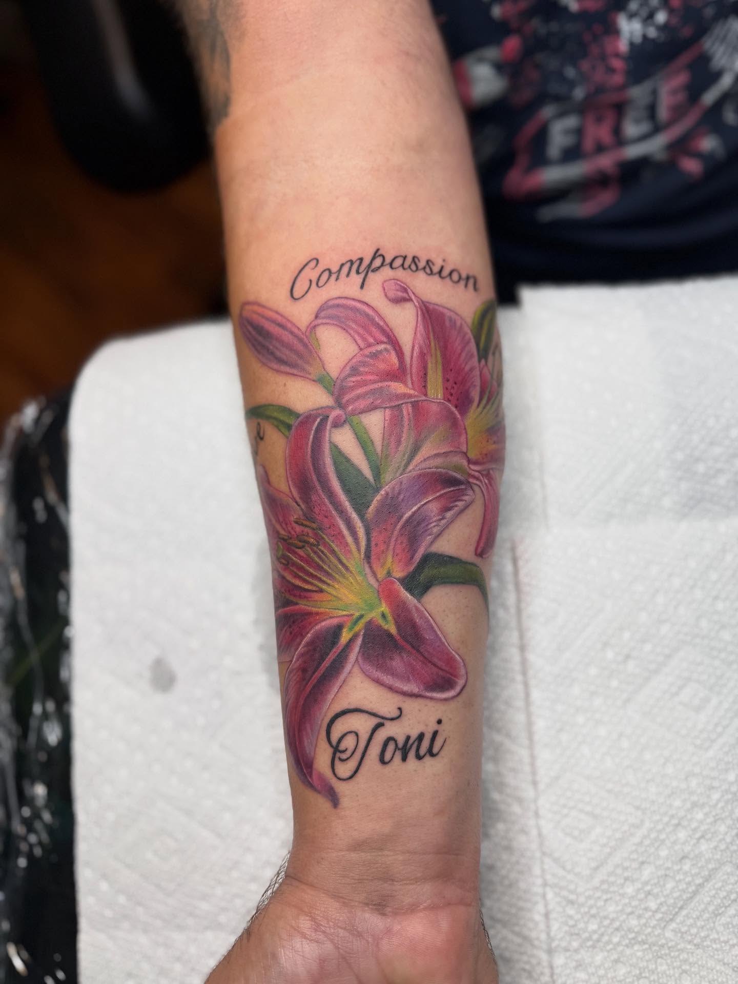 Lilies realism tattoo on the forearm by Kelsey Kemp