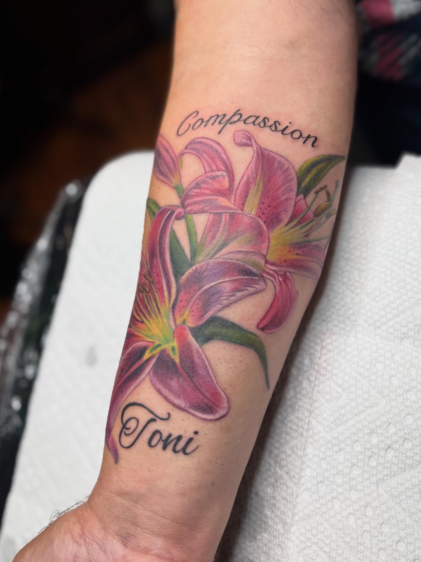 Lilies realism tattoo on the forearm by Kelsey Kemp