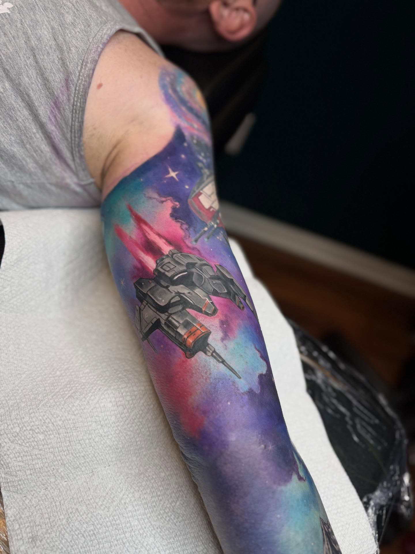 Space battle scene dotwork tattoo on the forearm by Kelsey Kemp