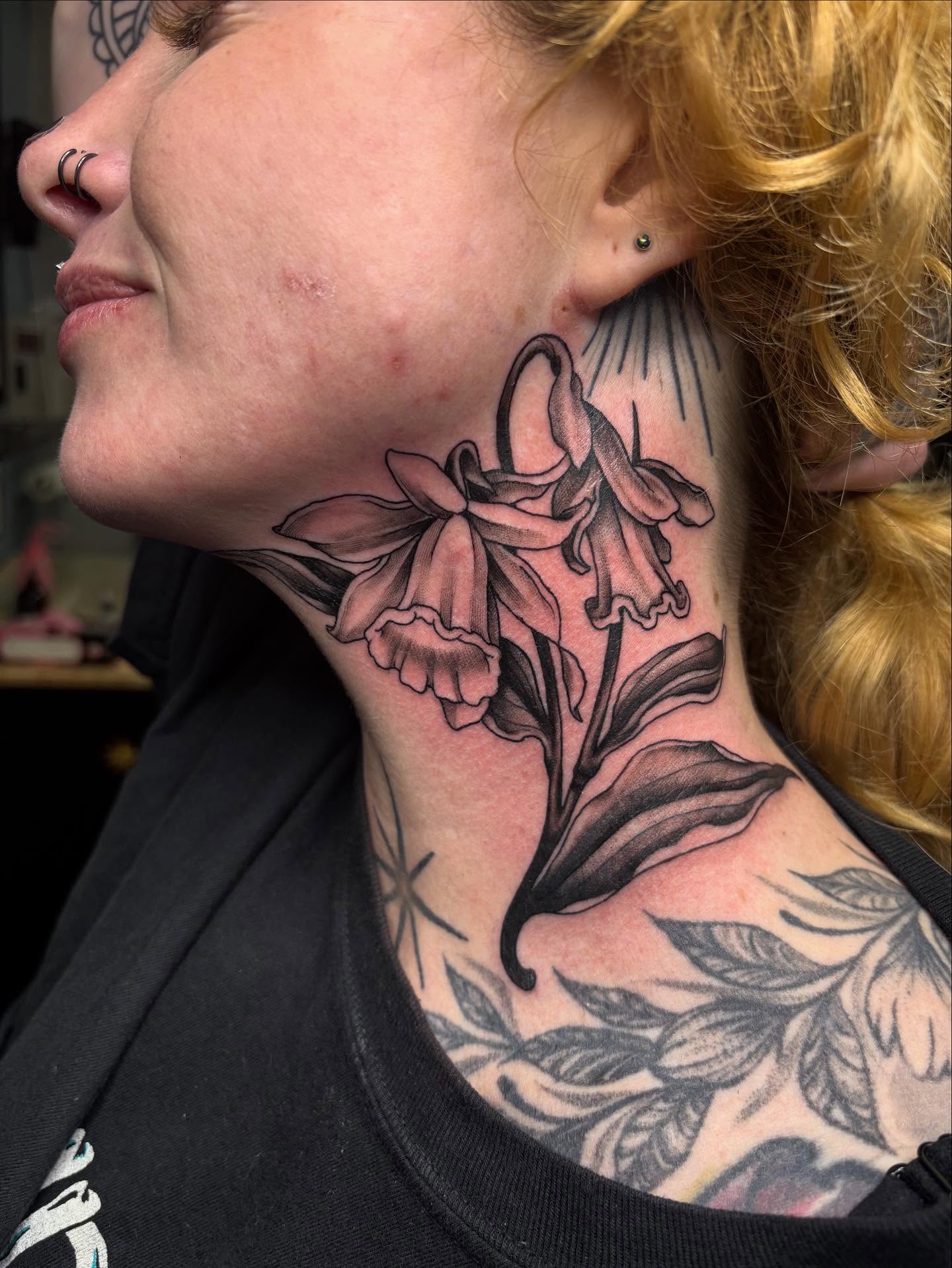 Daffodils black and grey tattoo on the neck by Jakob Ristau, Kansas City, Missouri