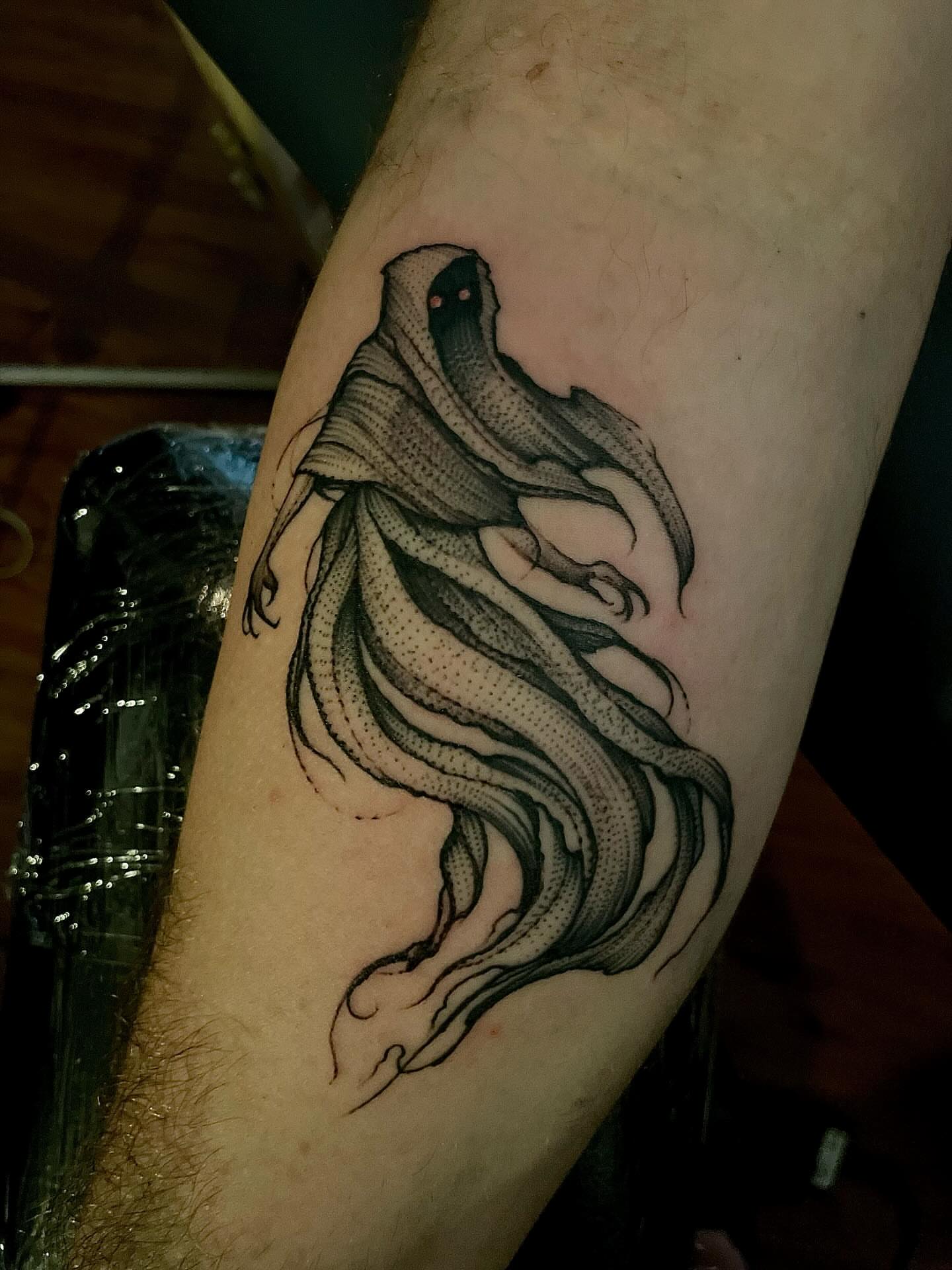 Ghostly figure dotwork tattoo on the forearm by Jacob Kearney