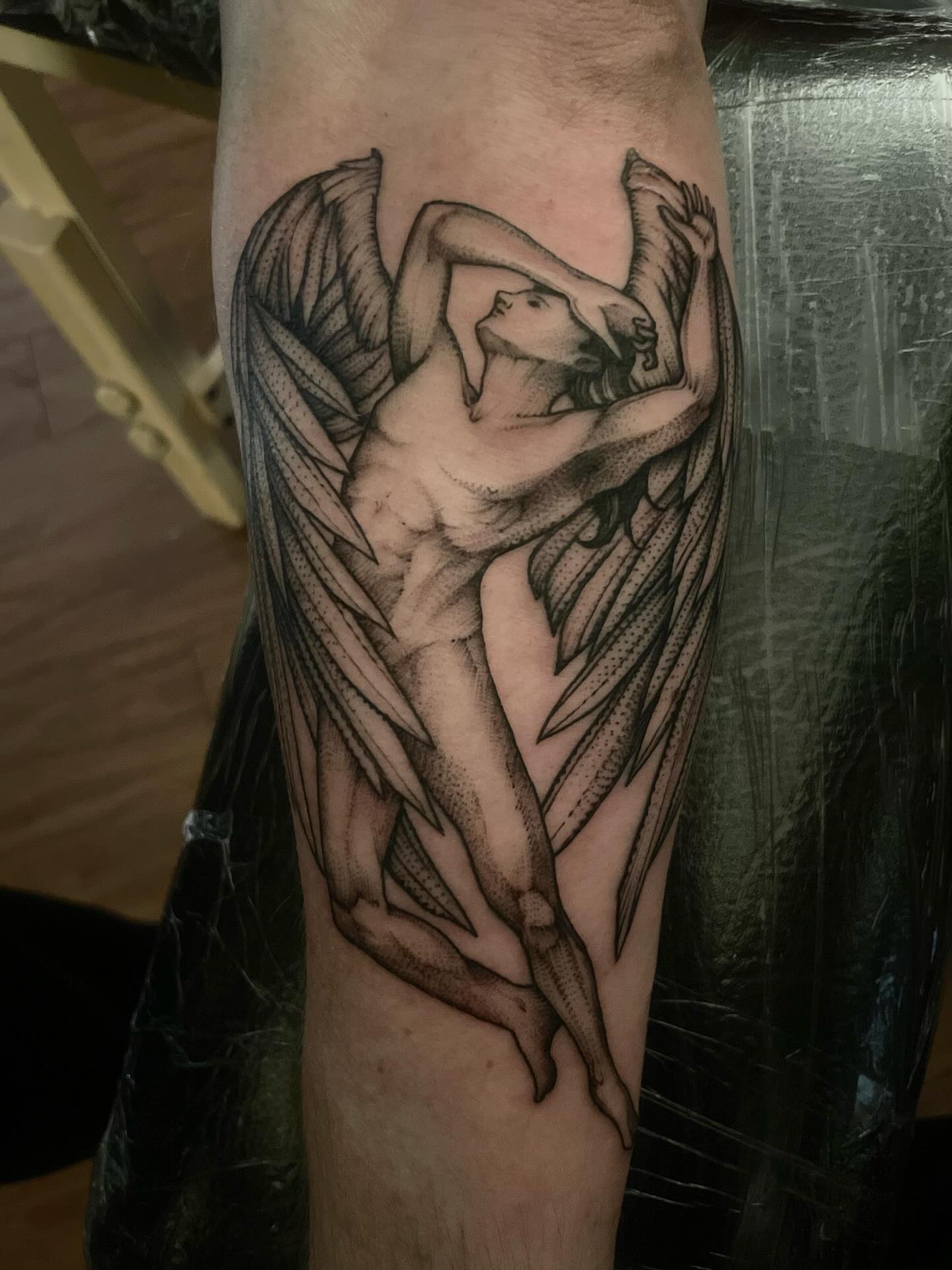 Winged angel realism tattoo on the forearm by Jacob Kearney