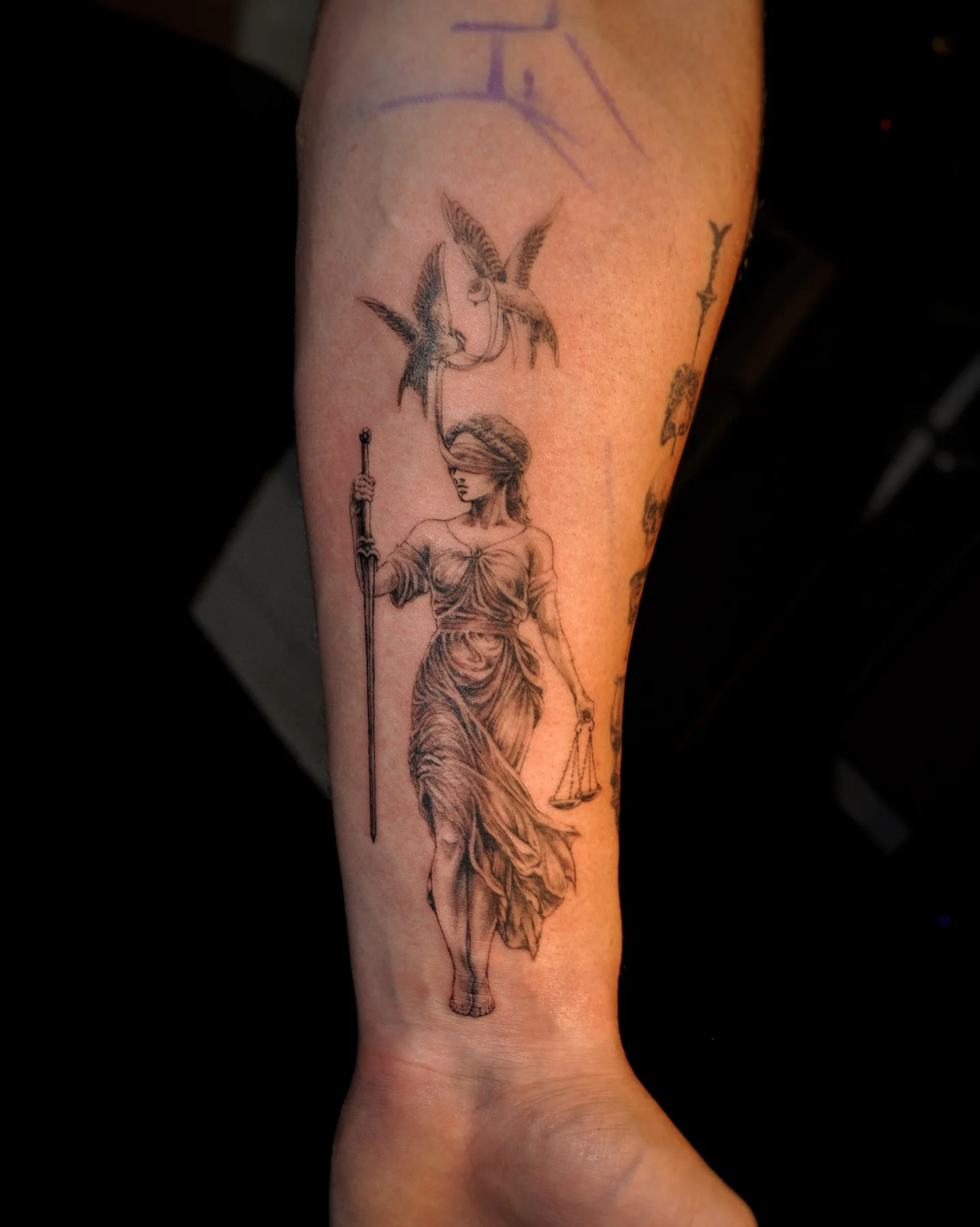 Statue of justice black and grey tattoo on the forearm by Bek Artz