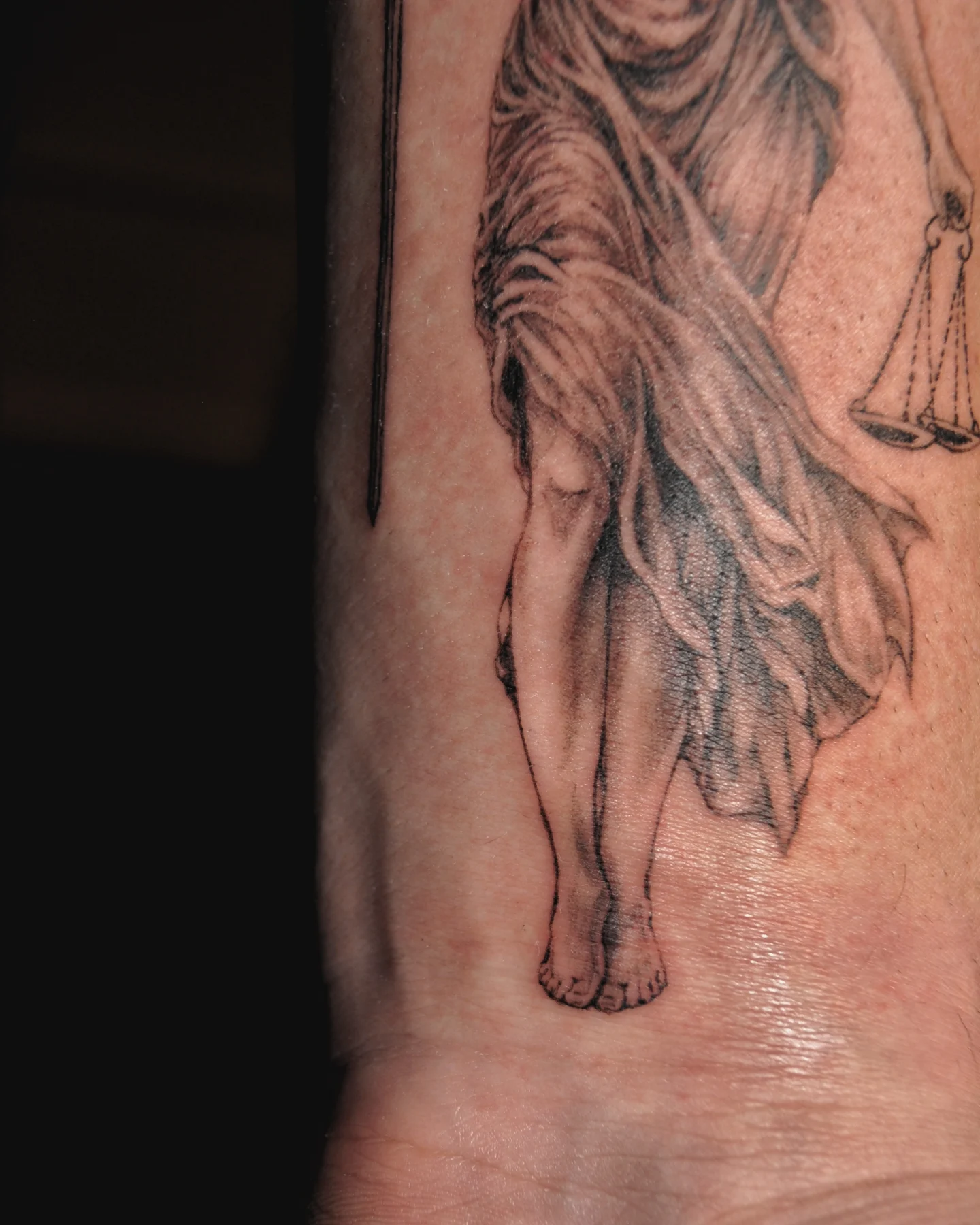 Statue of justice black and grey tattoo on the forearm by Bek Artz