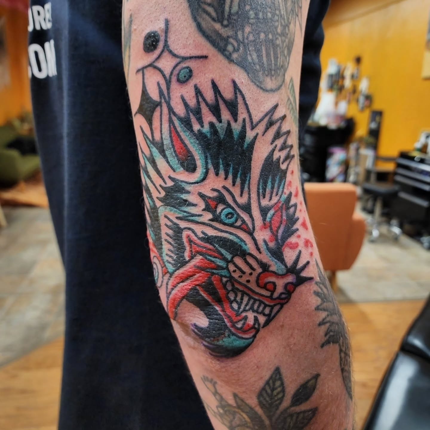 Wolf American traditional tattoo on the forearm by Mitch Braver