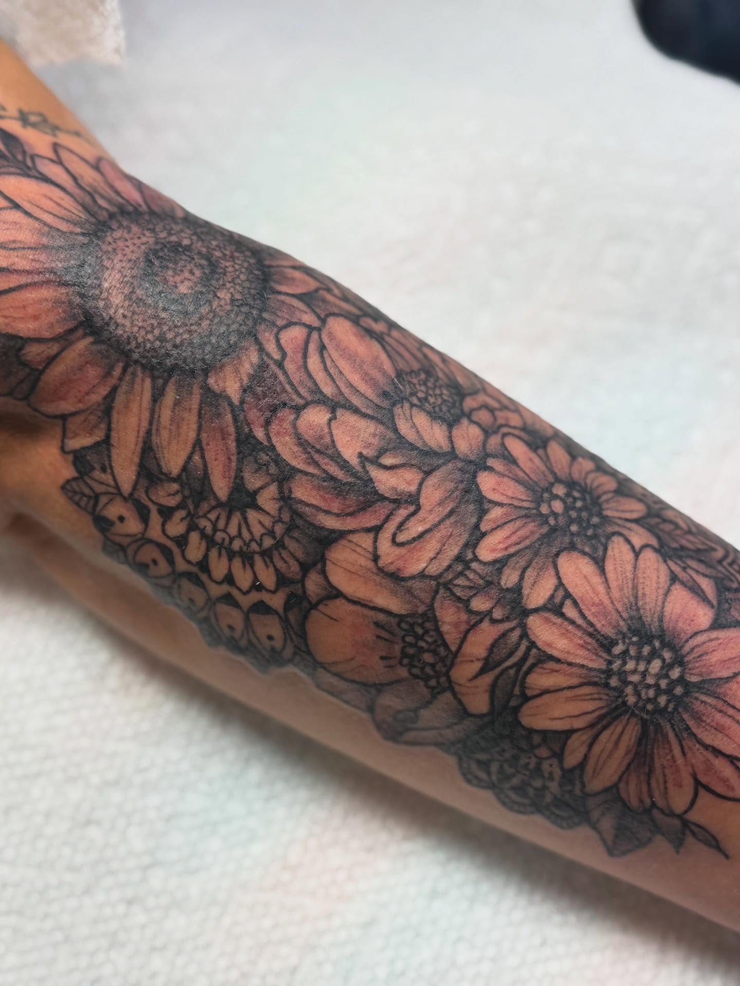 Sunflowers black and grey tattoo on the forearm by Tattoos By Trish