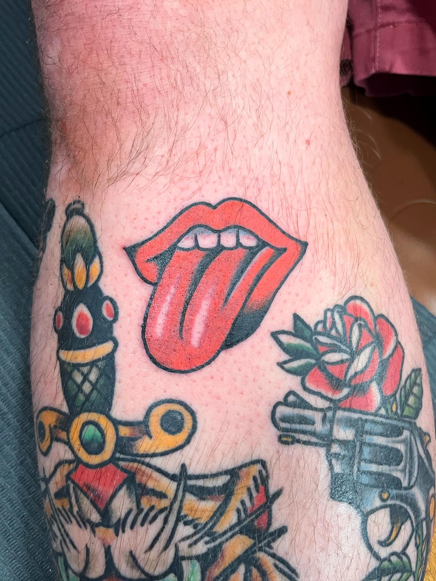 Rolling stones tongue American traditional tattoo on the forearm by Jake LiCausi