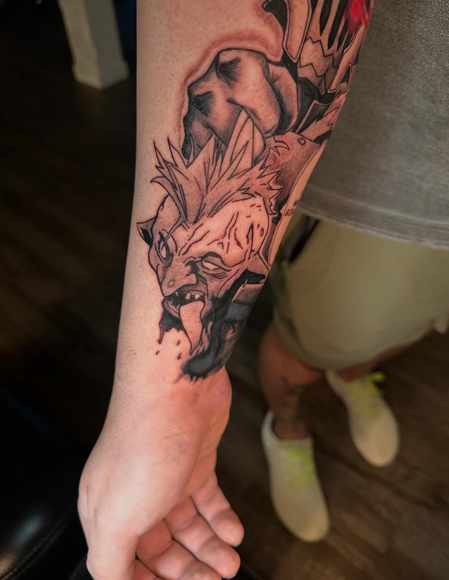 Demon head black and grey tattoo on the forearm by Damon Moore